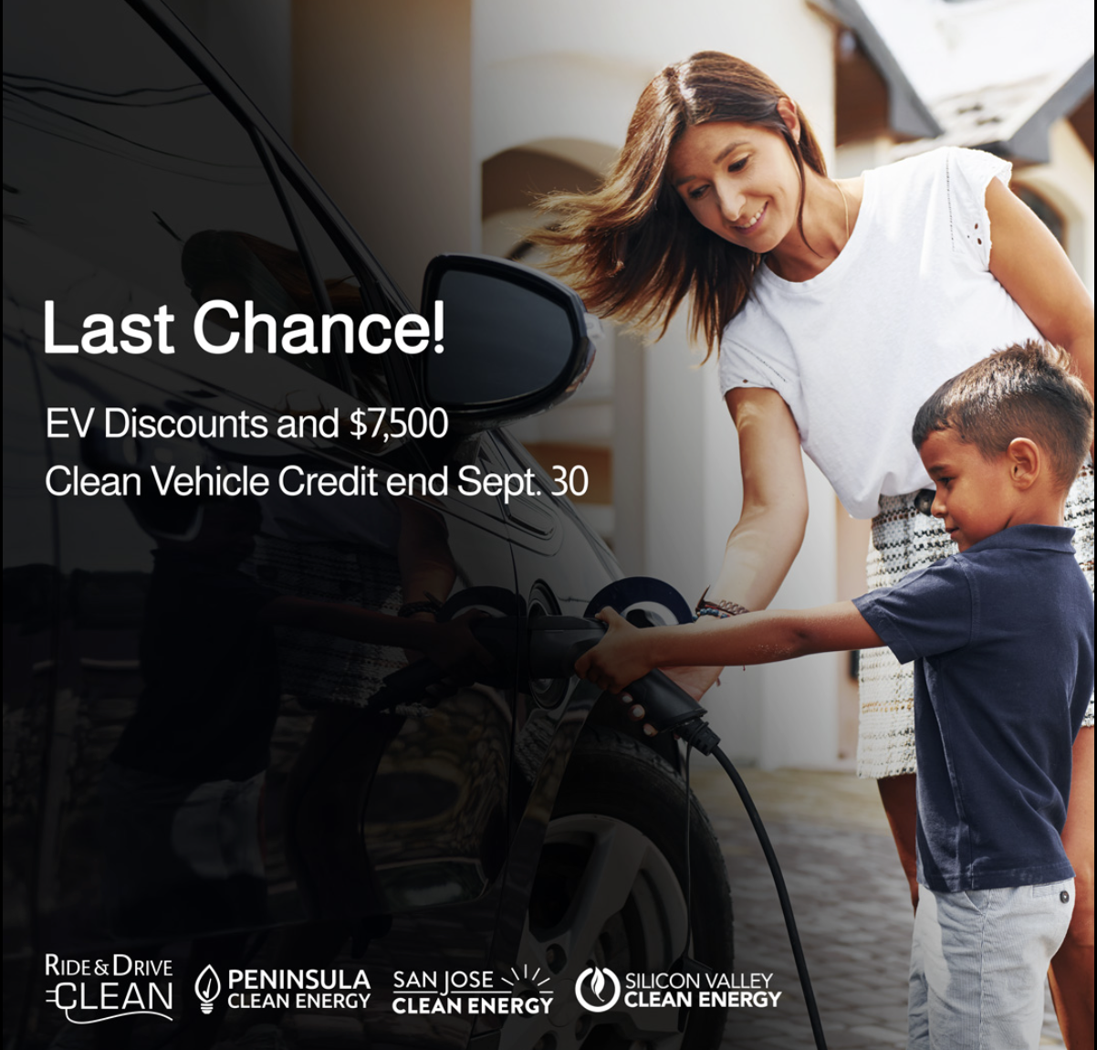 A woman and young boy plugging in an EV