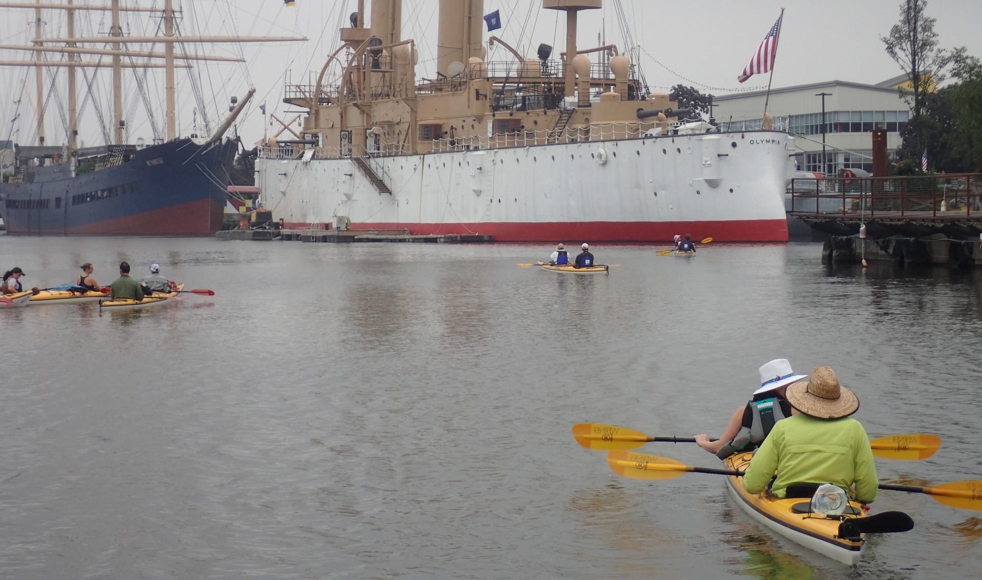kayakers in front of a historic ship in Philadelphia