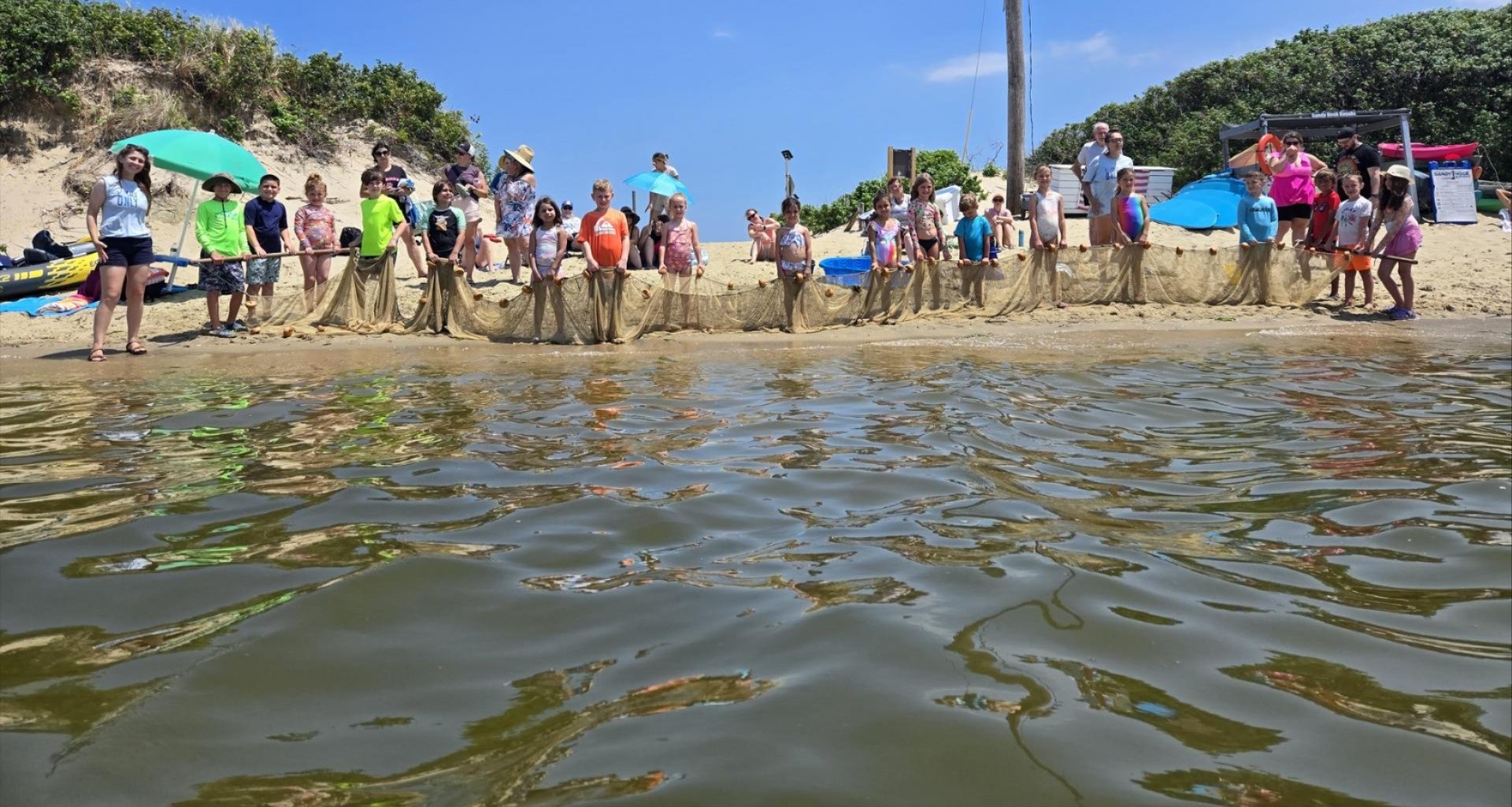 young people examining seining catch on Sandy Hook