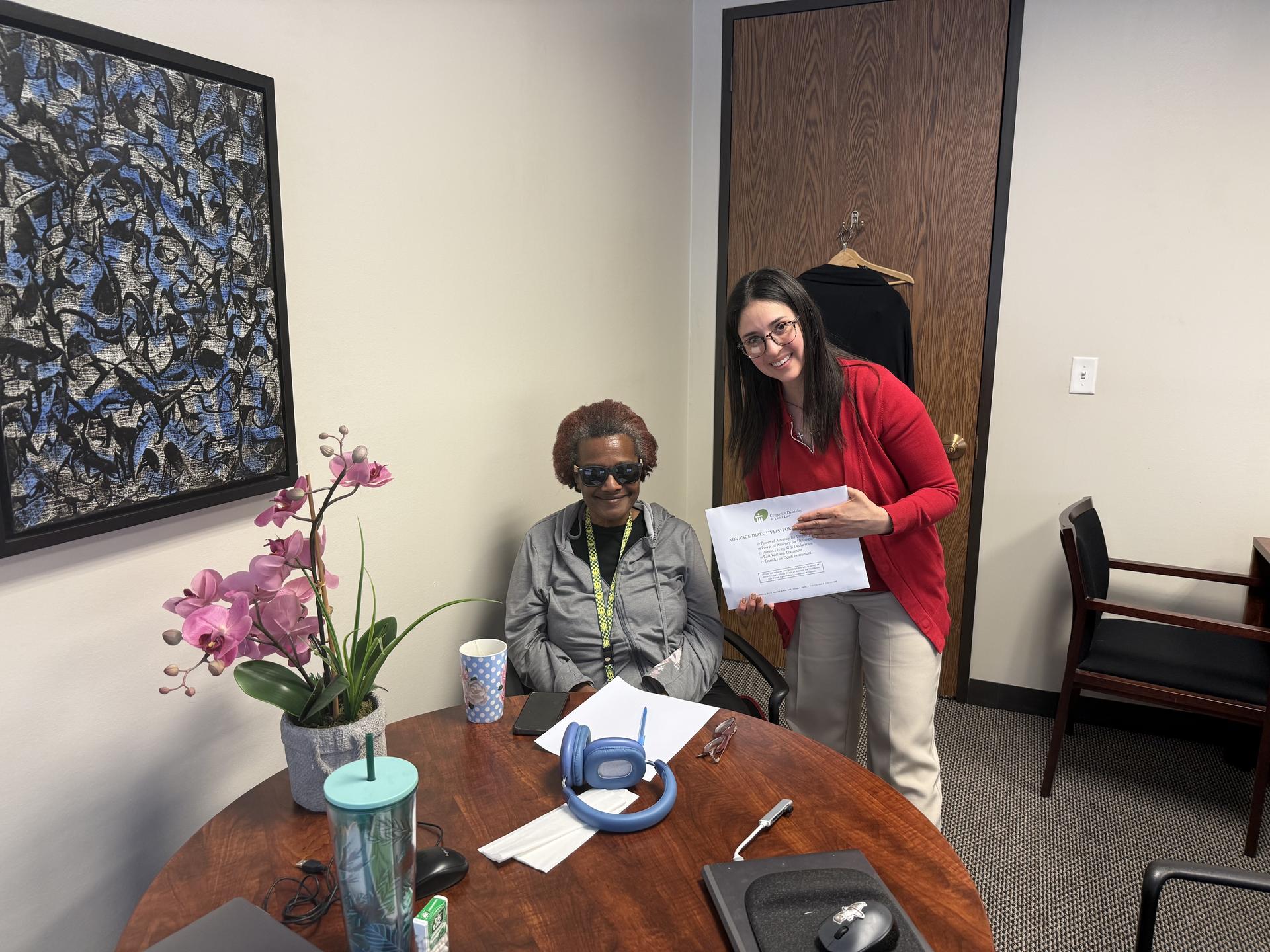 CDEL Staff Attorney Lissette Ortegon and client Maggie with her executed estate planning documents at CDEL's office
