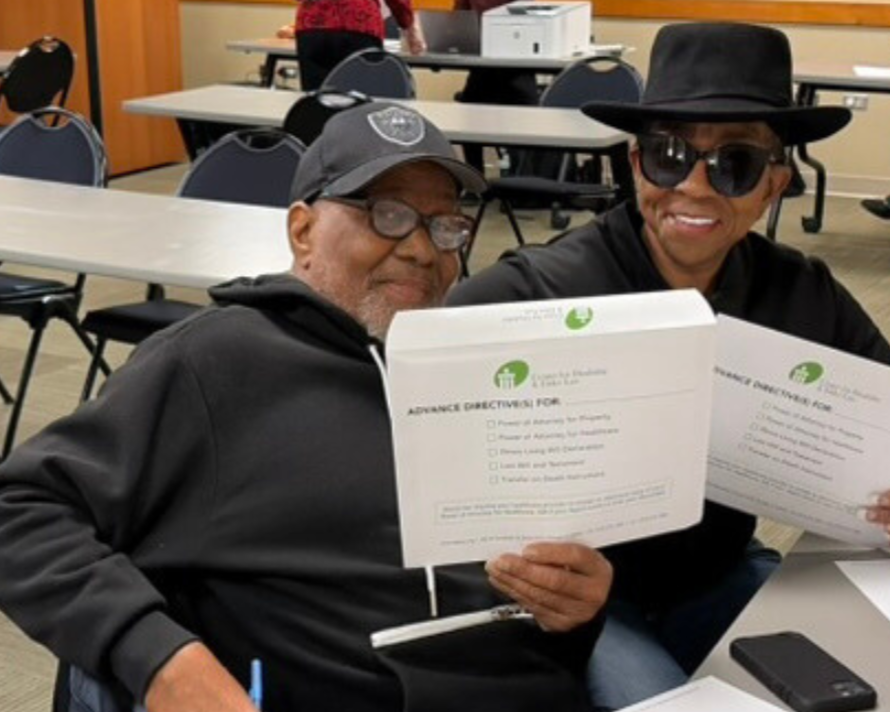 CDEL clients holding up their completed documents at CDEL’s 11.15 weekend POA Workshop event