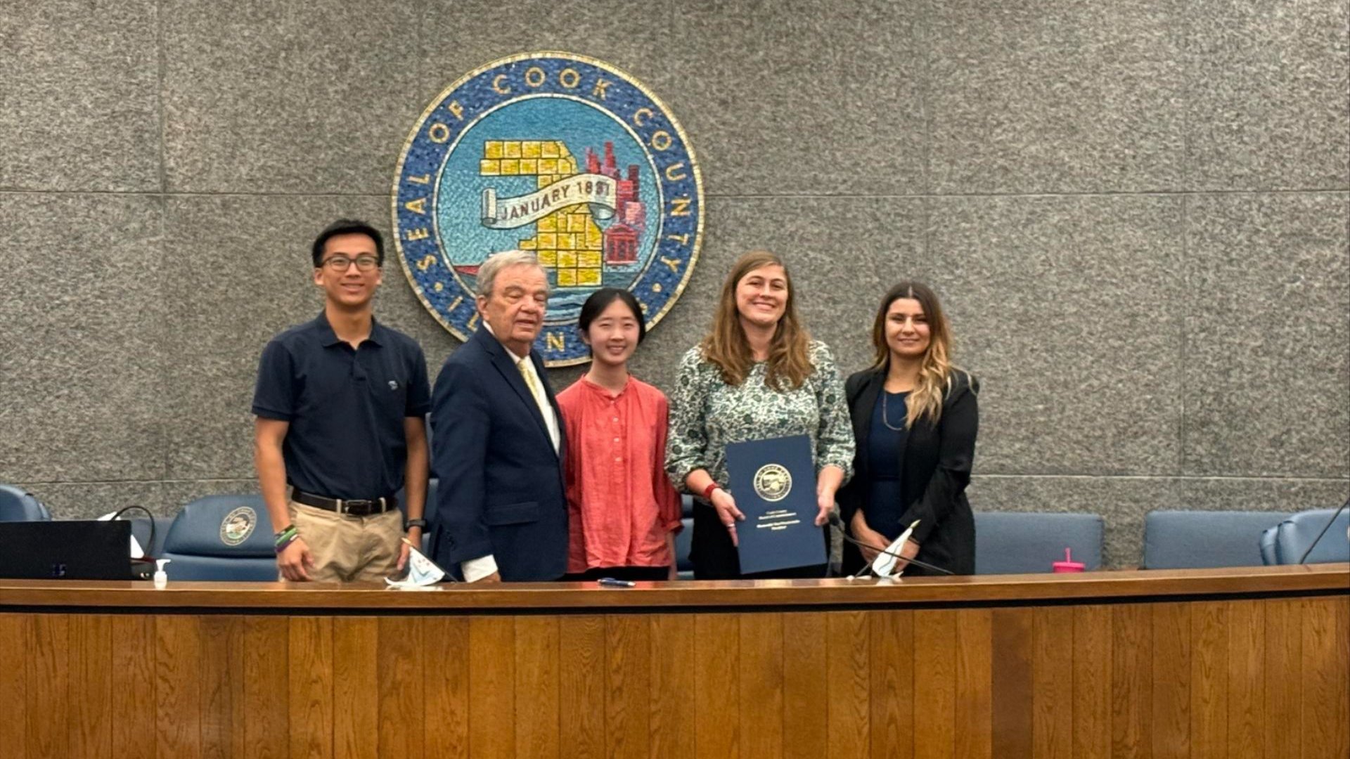 CDEL Policy & Advocacy Manager Julia Epplin-Zapf and CDEL interns accepting the proclamation with Cook County Commissioners Alma Anaya and John P. Daley