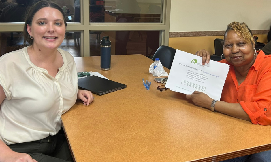 CDEL client with a CDEL volunteer holding up completed POA documents at CDEL’s July 14th POA Workshop in Matteson