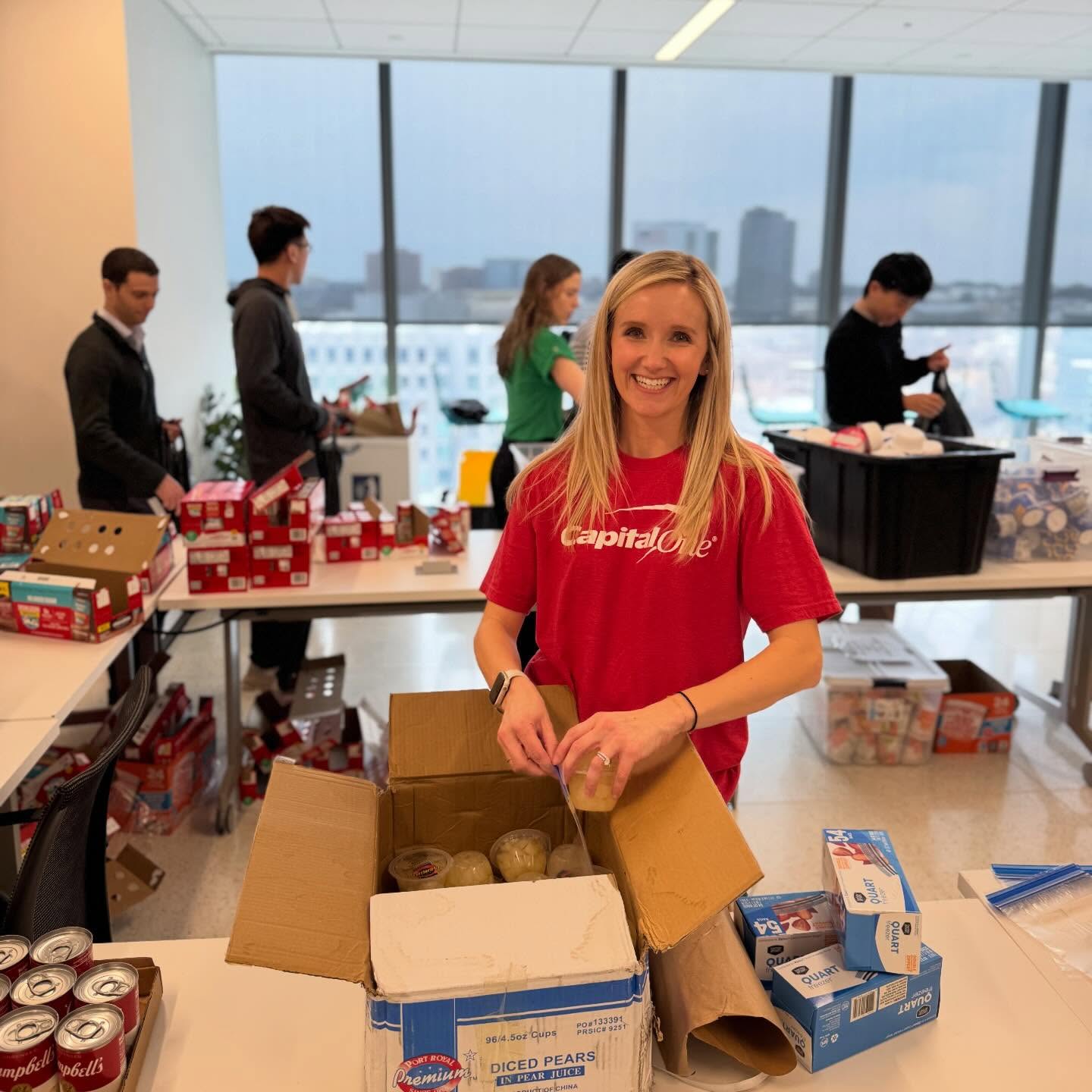 Capital One employees packing Backpack Buddies bags in their office