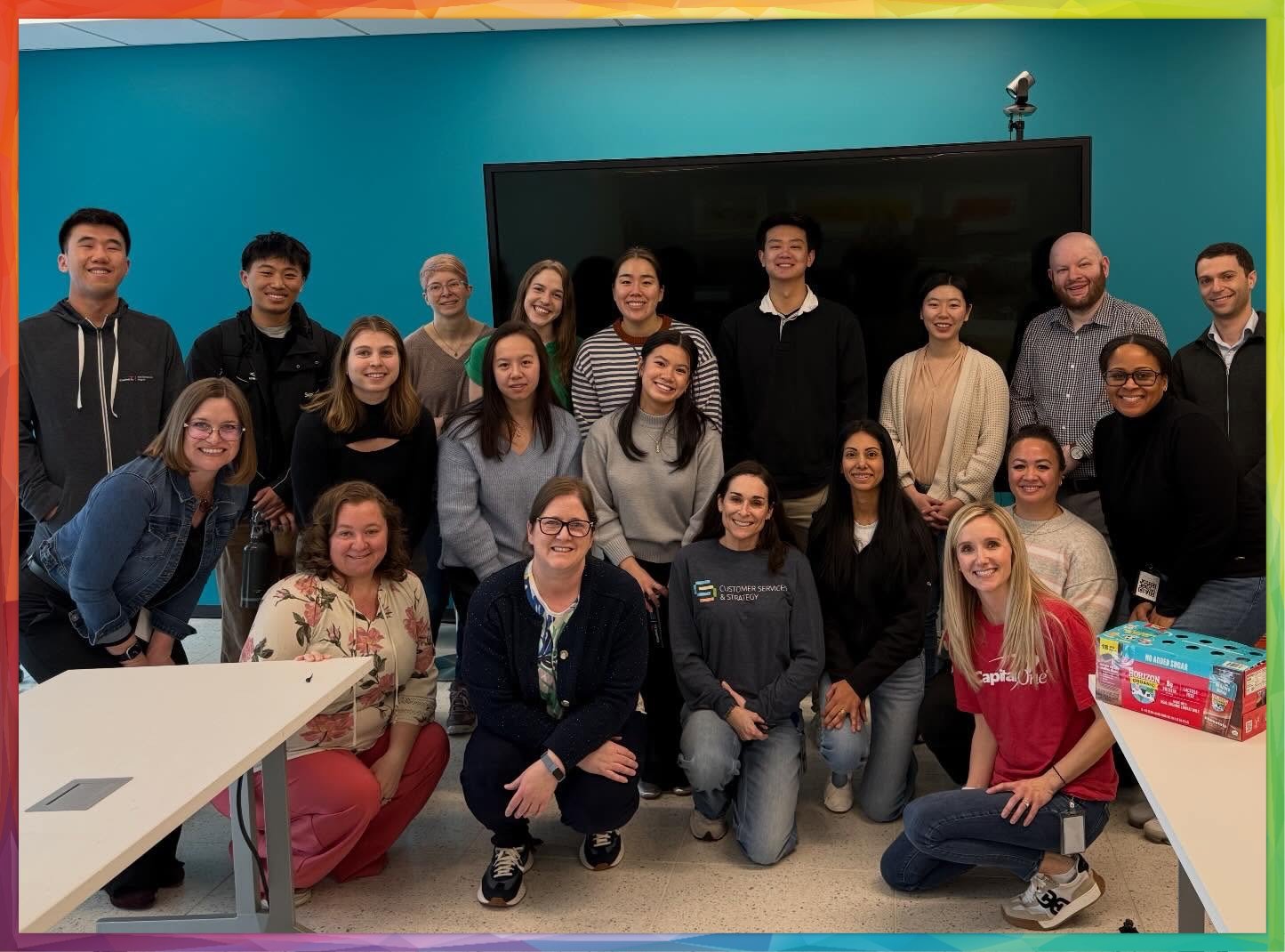 Capital One employees standing and kneeling in a group