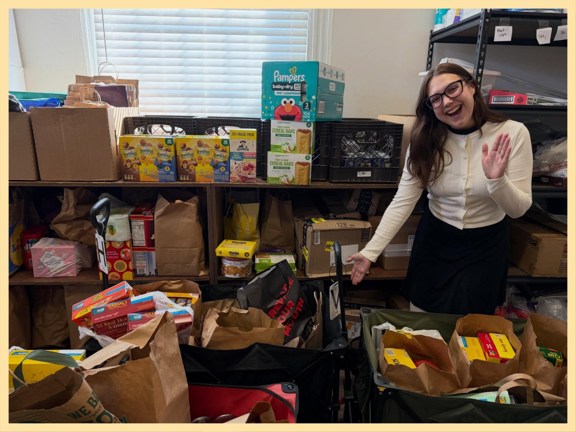 Person standing next to shelves and wagons full of donations