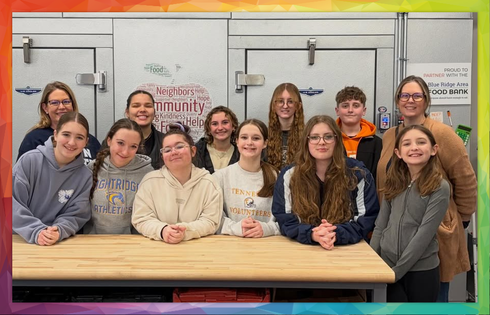 Members of AUMC standing together in front of Pantry refrigerator