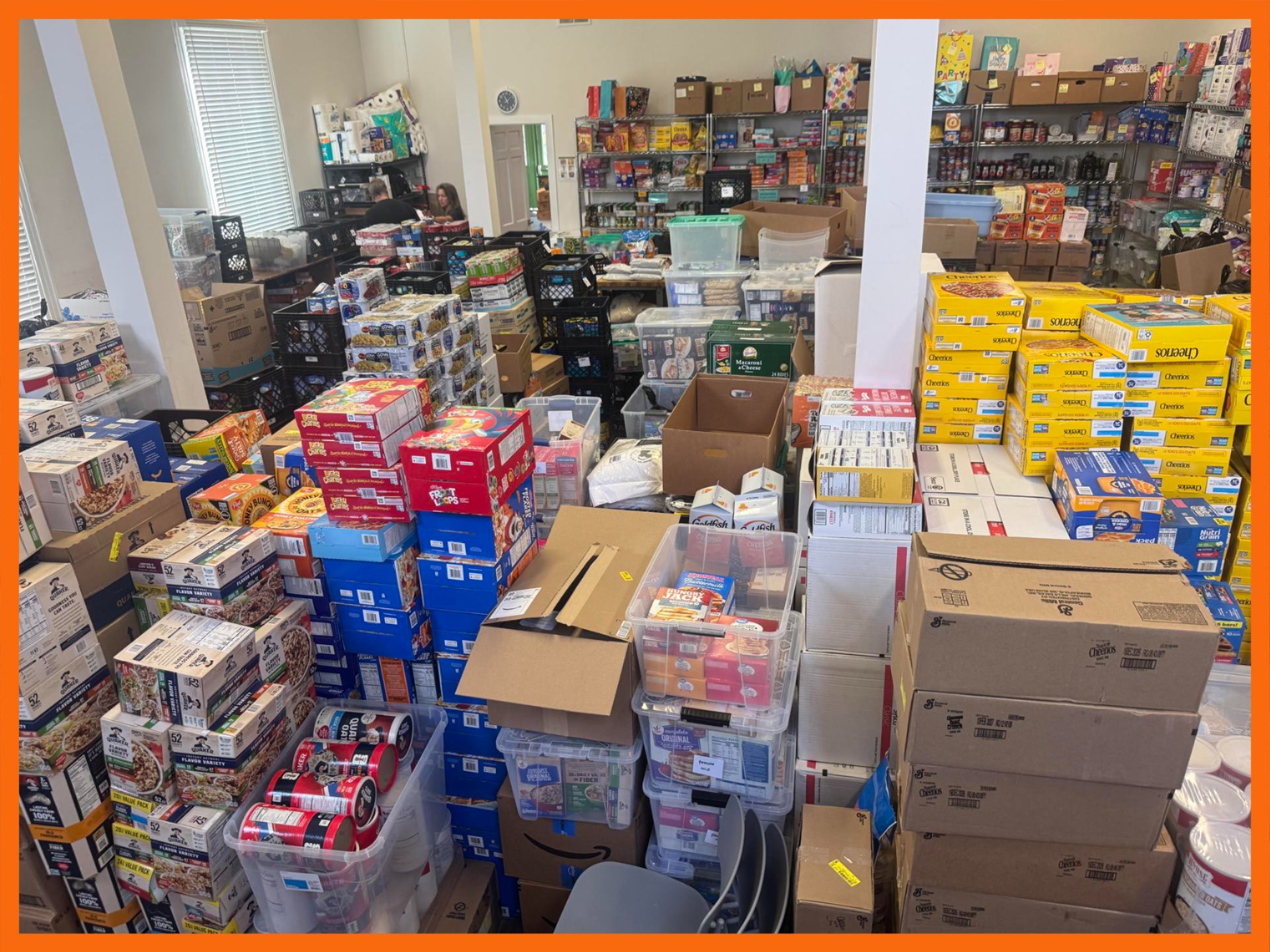 Room full of food donations in boxes and crates