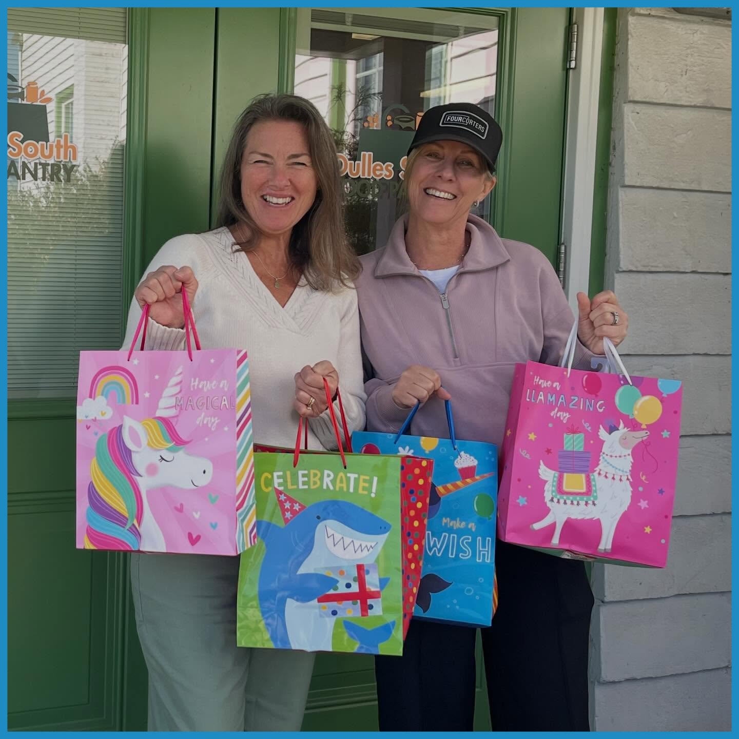 Two women posing in front of the DSFP door with birthday gift bags