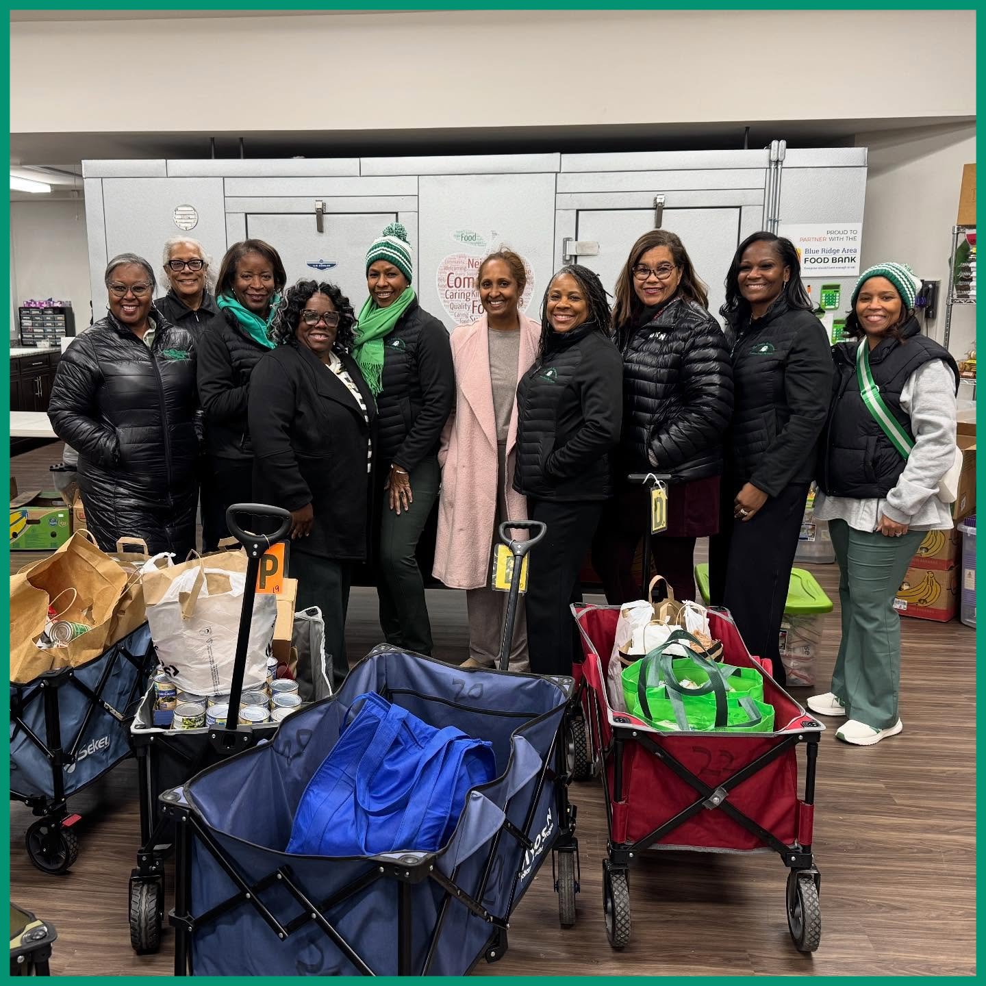 Members of the Links, Inc standing behind wagons full of donations