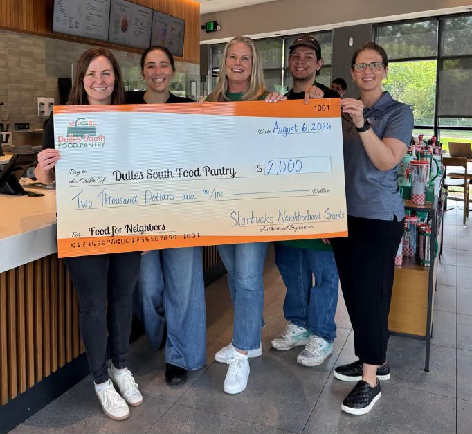Starbucks employees and Pantry staff posing inside a Starbucks location with a ceremonial check