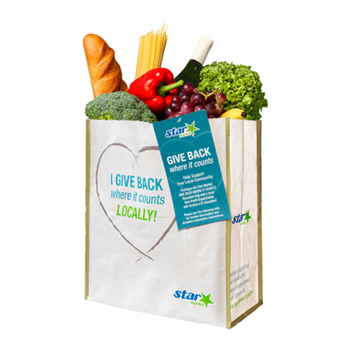 Give where it counts bag full of vegetables, pasta, wine, and bread