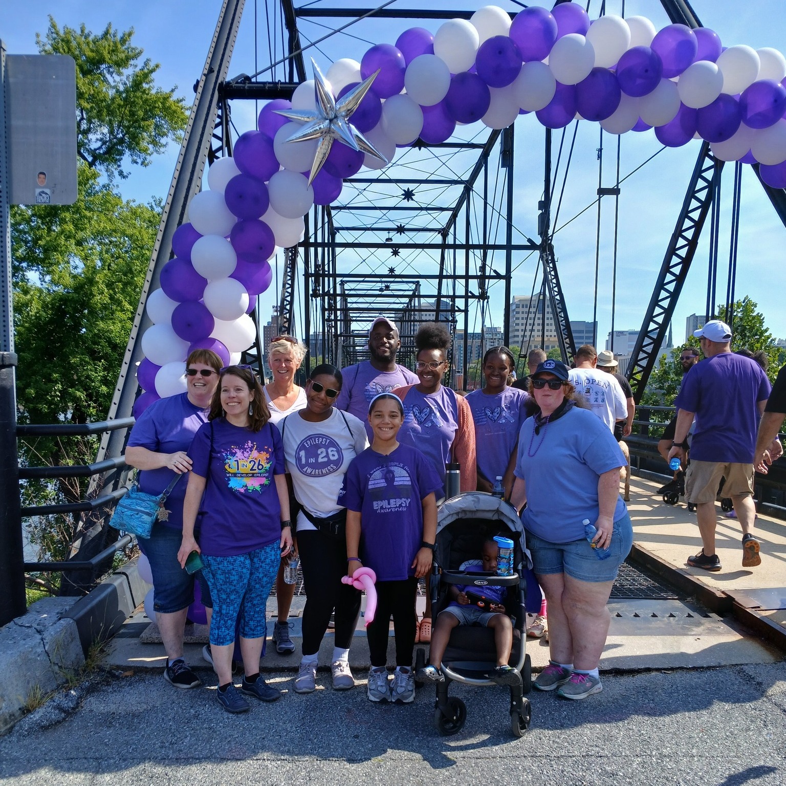 walkers on a bridge in piitsburgh 