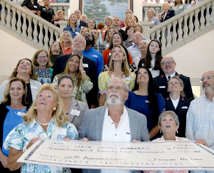 GHCOP Board Members with award recipients standing on the grand staircase with a large check made out to GHCOP awardees for $725,000
