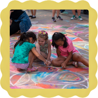 Three kids draw with chalk on a colorful sidewalk