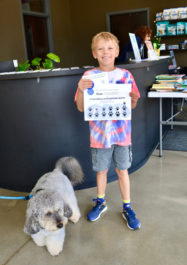 Ivan with canine Book Buddy Darby