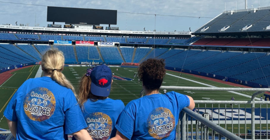 Legal Aid employees at Highmark Stadium, wearing t-shirts that say 