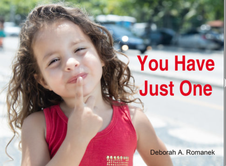 Girl holding one finger to her mouth