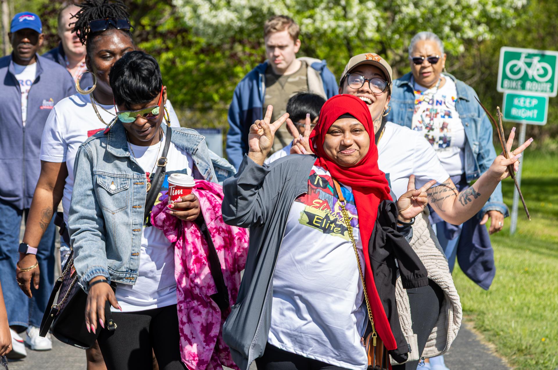 A group of walkers wave at the camera.