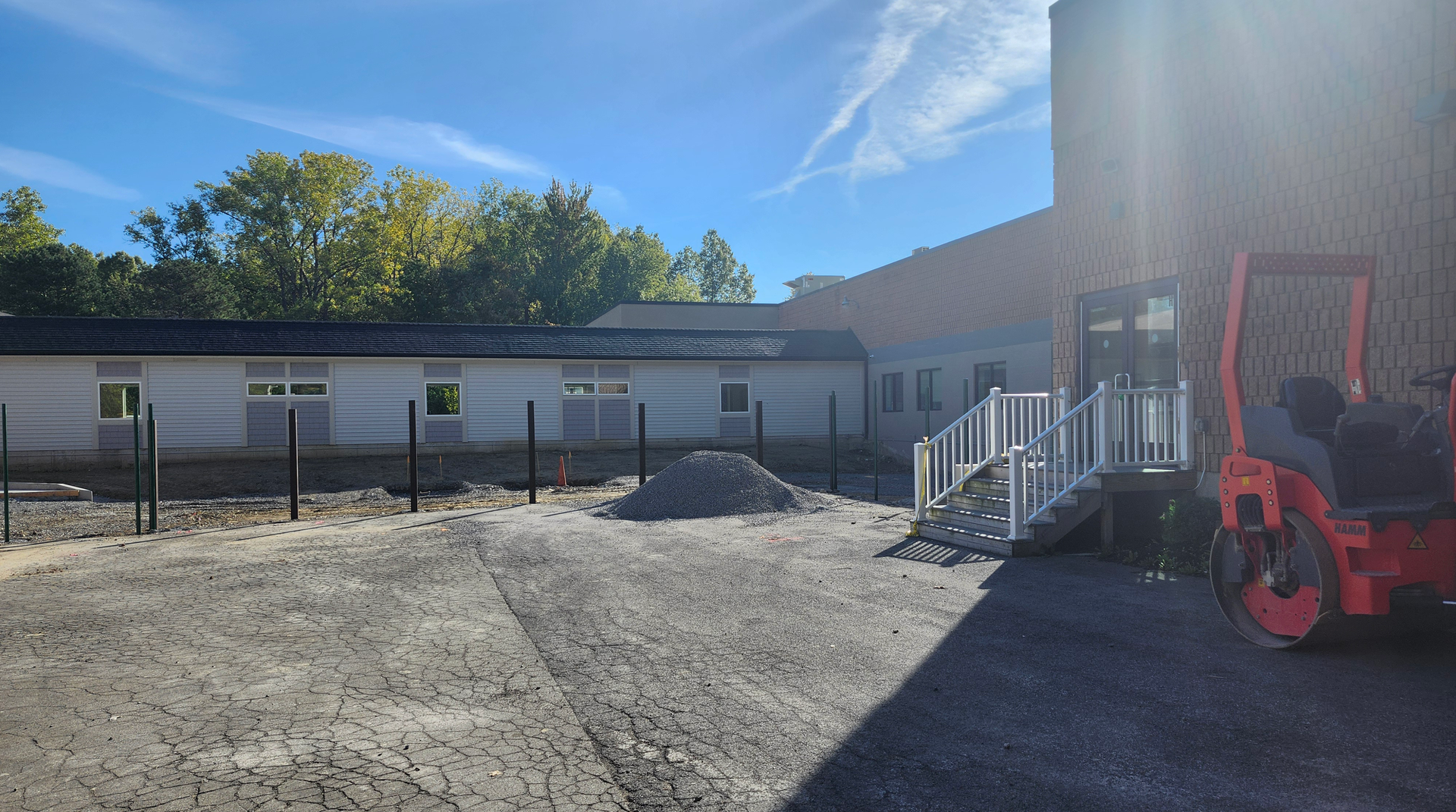 Posts line the dug up surface outside a building where a courtyard will go.