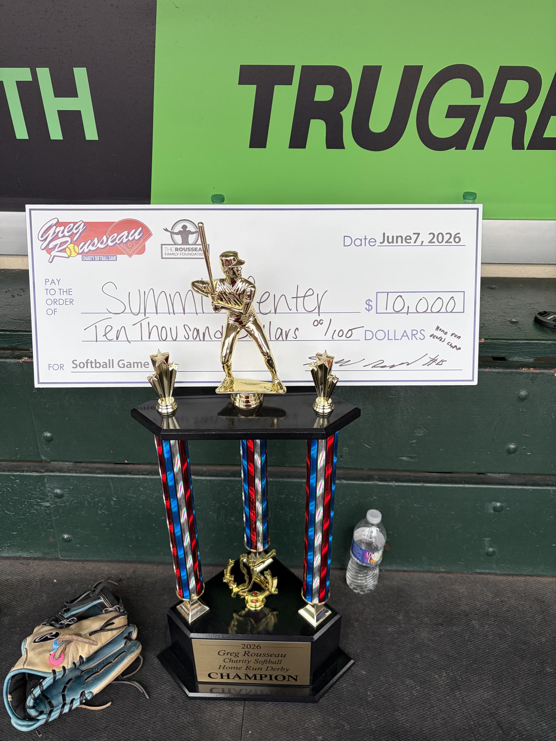 A trophy, baseball mitt, and check for The Summit Center