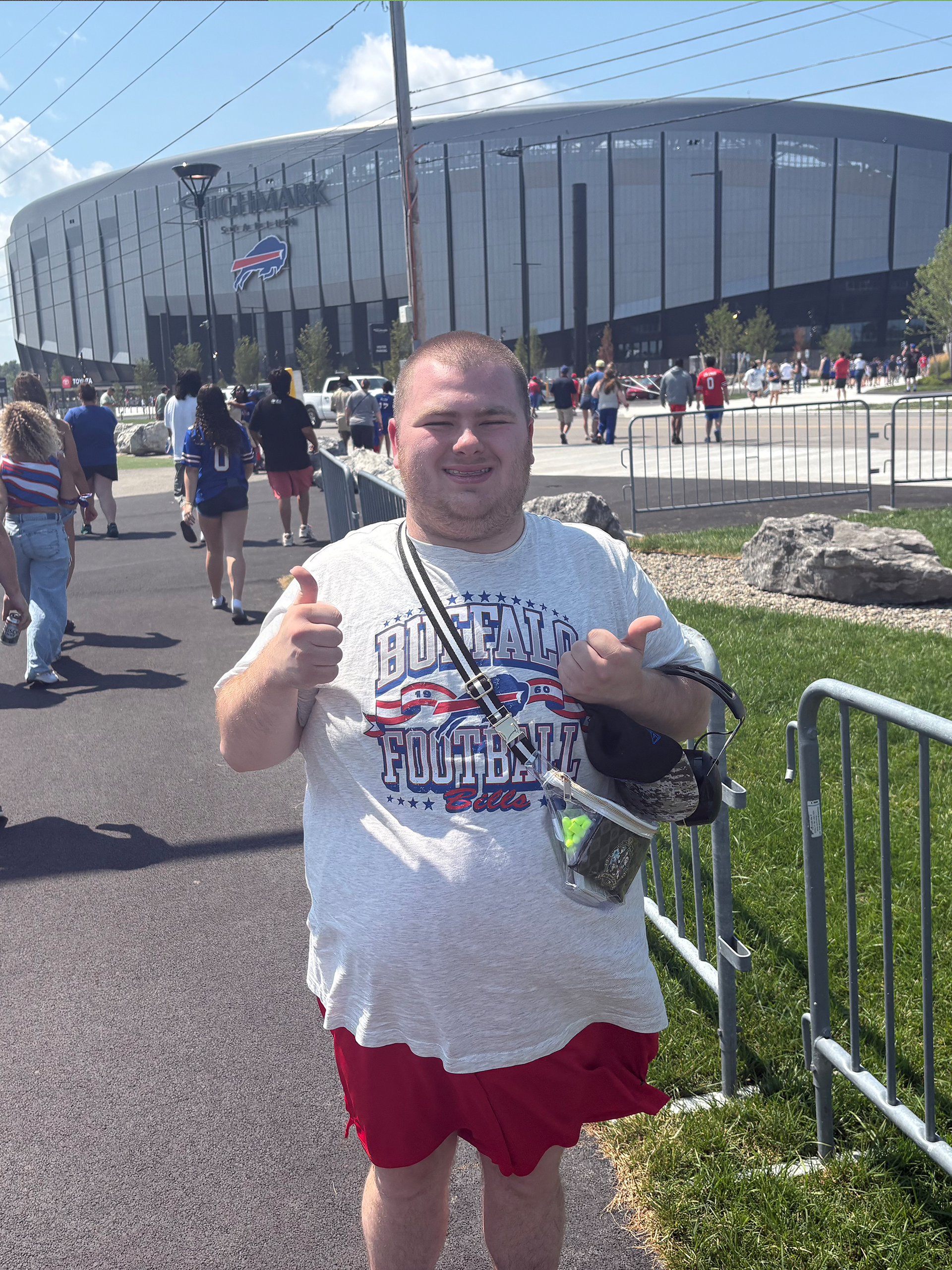 A young man gives the thumbs up outside Highmark Stadium.