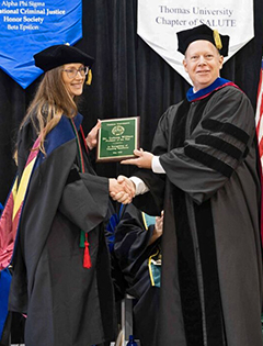 Dr. LeAnna Willison receives the 2026 Professor of the Year Award from Dr. John Meis, Provost.