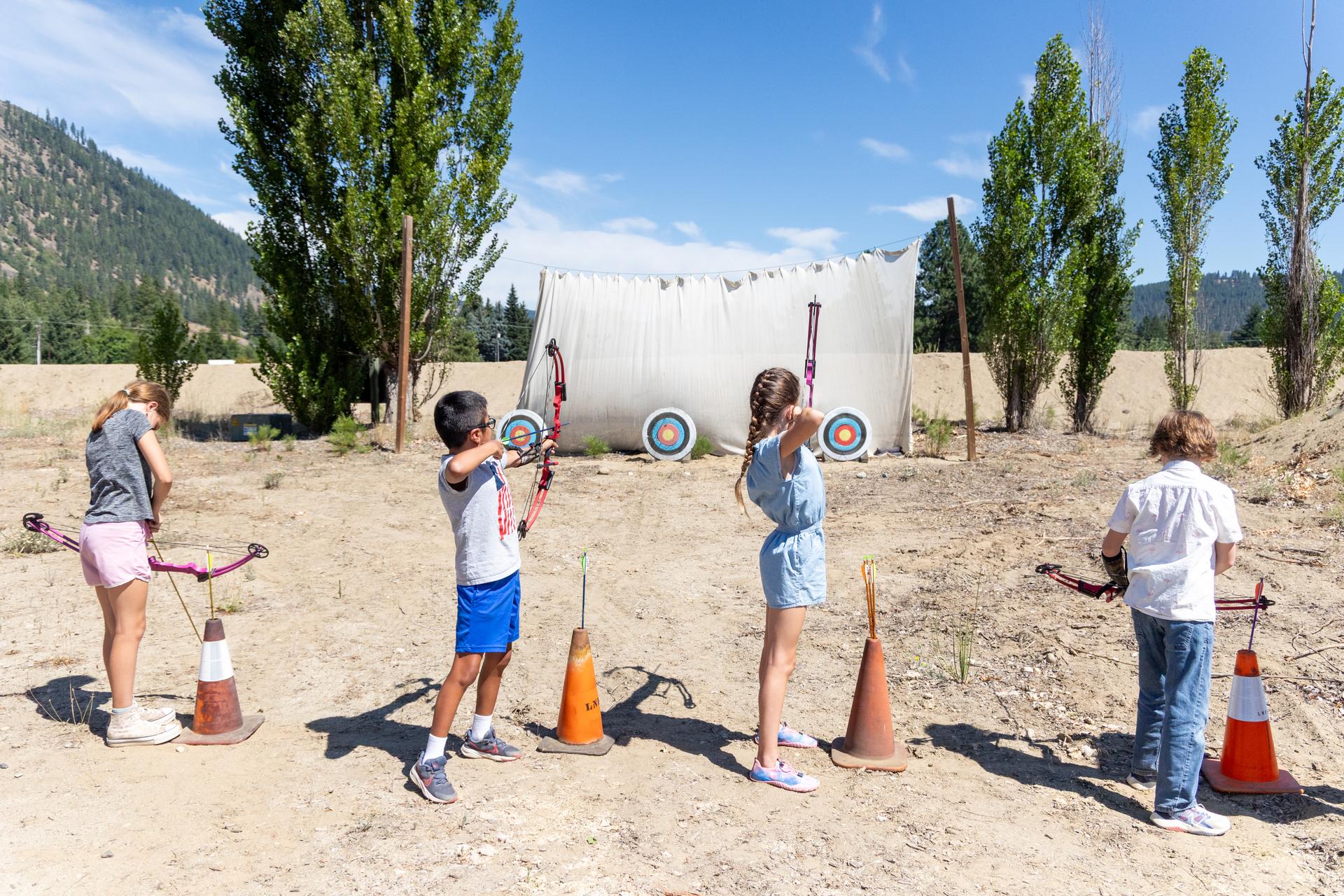 Summer Camp kids practicing archery skills.