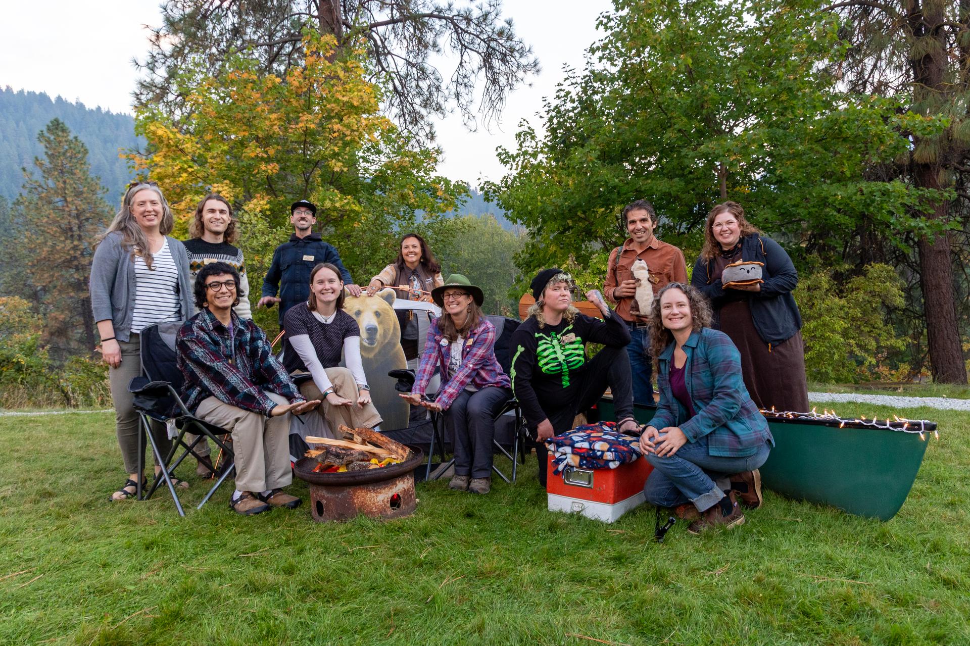 A picture of WRI staff at a camp-themed photo set up during Sunset & S'mores event.