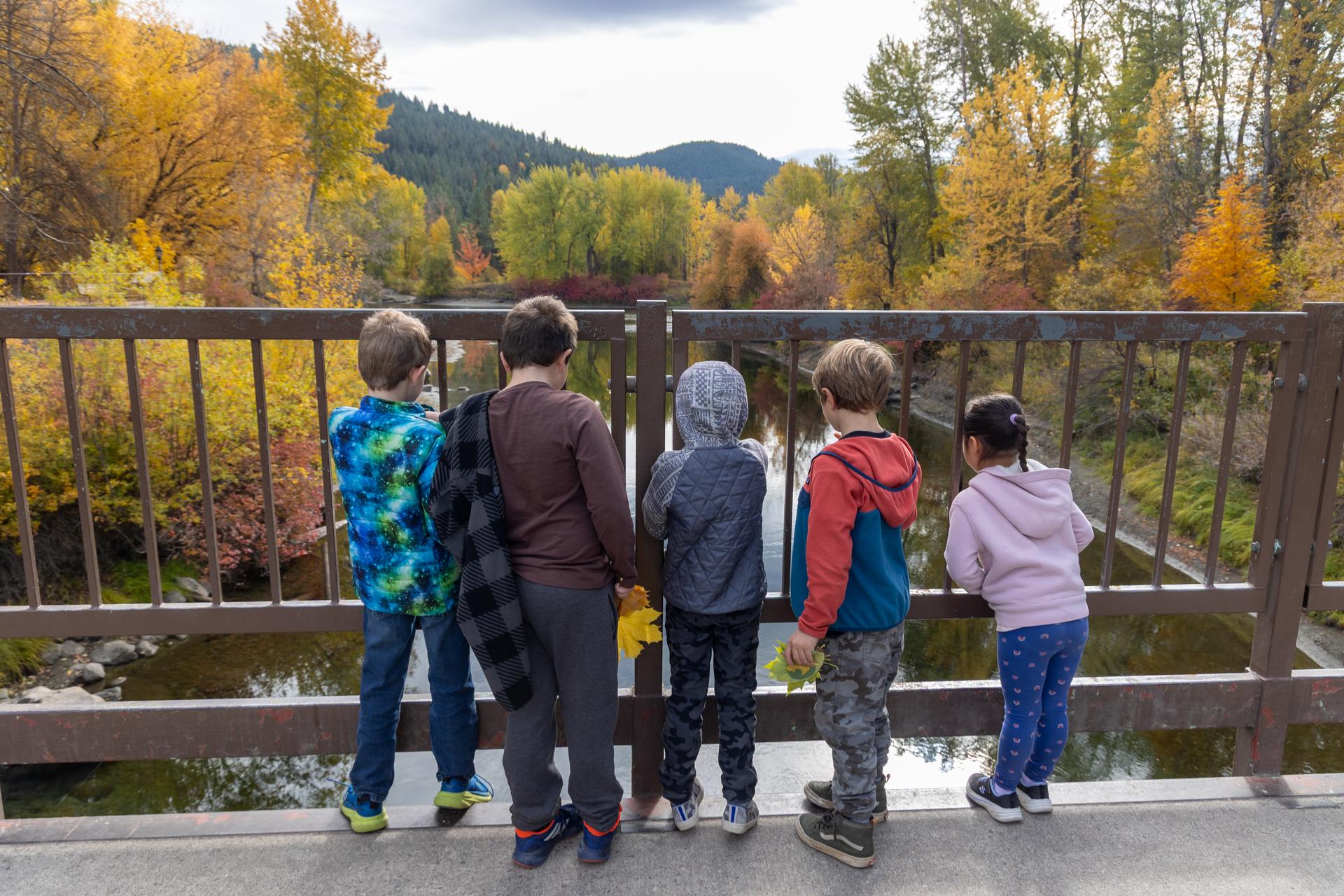 Image of Fall Camp with students looking in the Wenatchee River from the bridge.