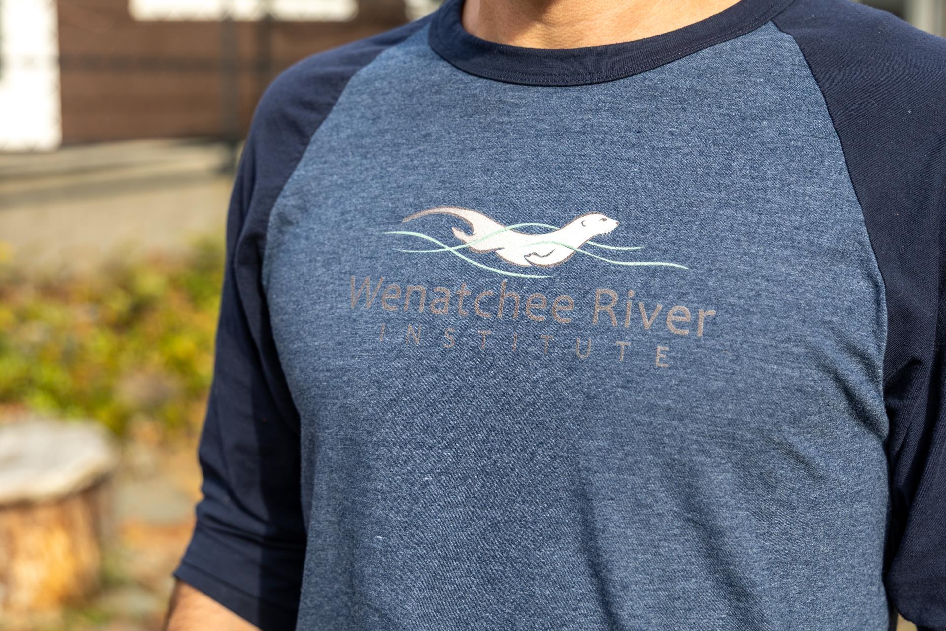 A graphic with WRI staff wearing WRI merchandise and promoting the store for holiday shopping.