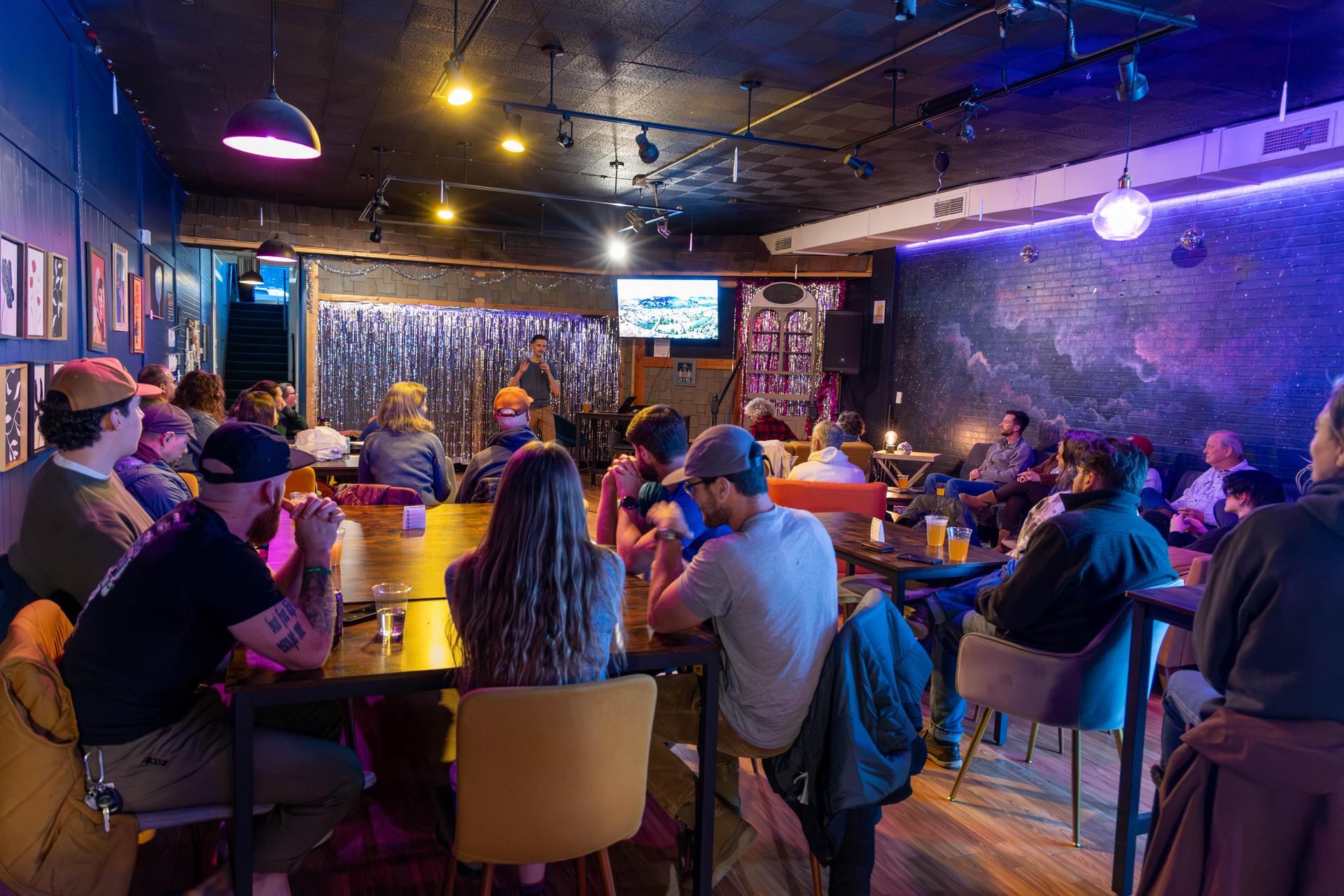 Photo of Brock presenting Weather Whiplash during a Science on Tap with Wenatchee River Institute at Ground Control in Wenatchee.
