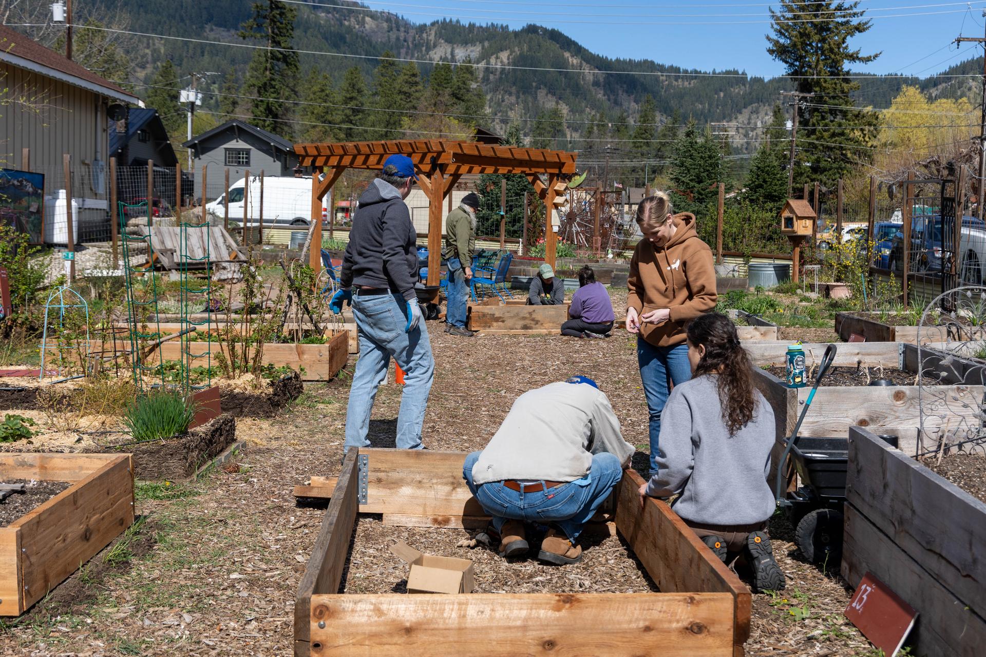 Volunteers helping assemble planter boxes for the WRI Community Garden.
