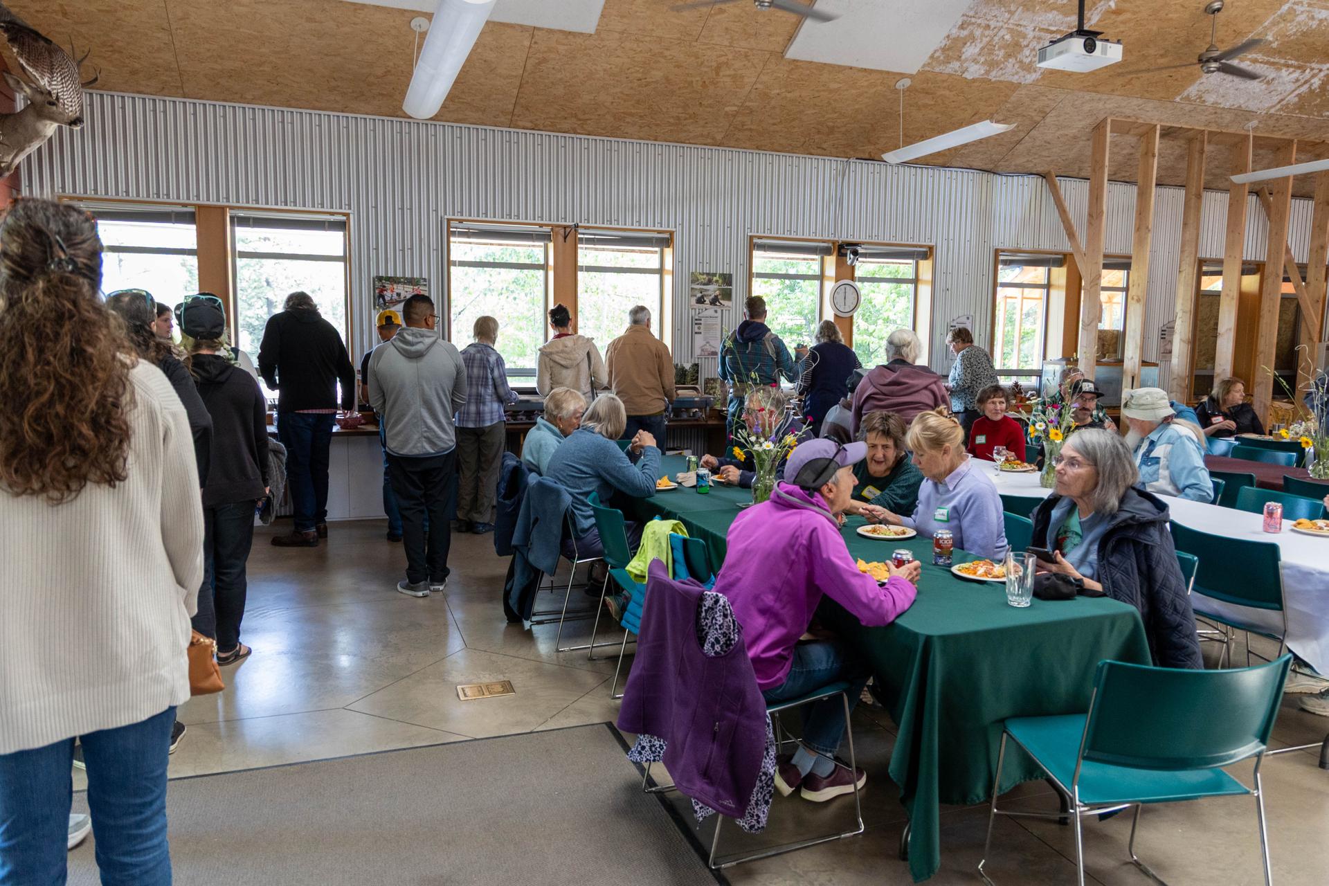 WRI volunteers lined up and enjoying a catered meal from El Chavo during the annual Volunteer Appreciation Dinner in the Red Barn.