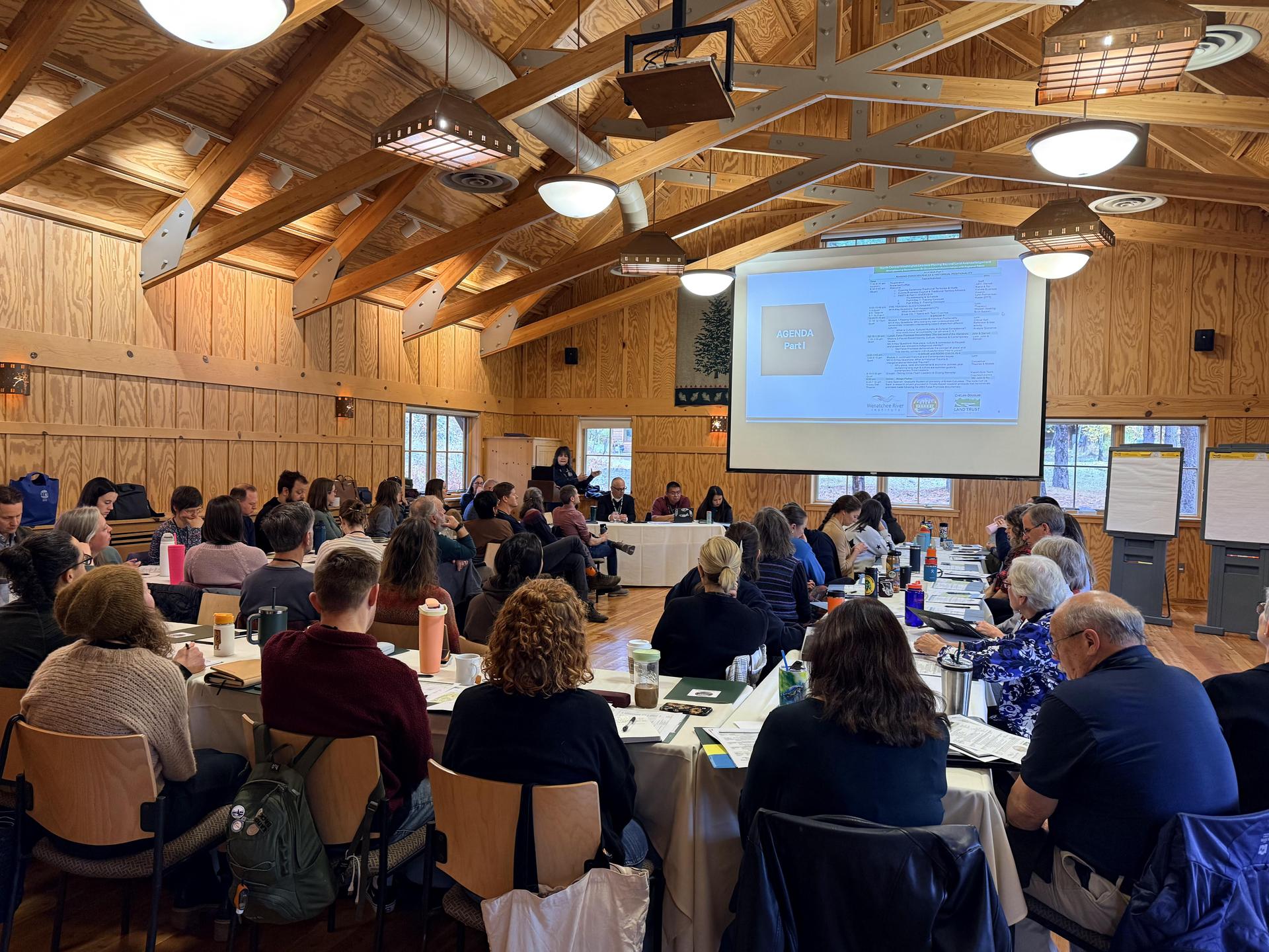 A picture of a conference room of people during the Move Beyond Land Acknowledgement retreat held at Sleeping Lady Resort.