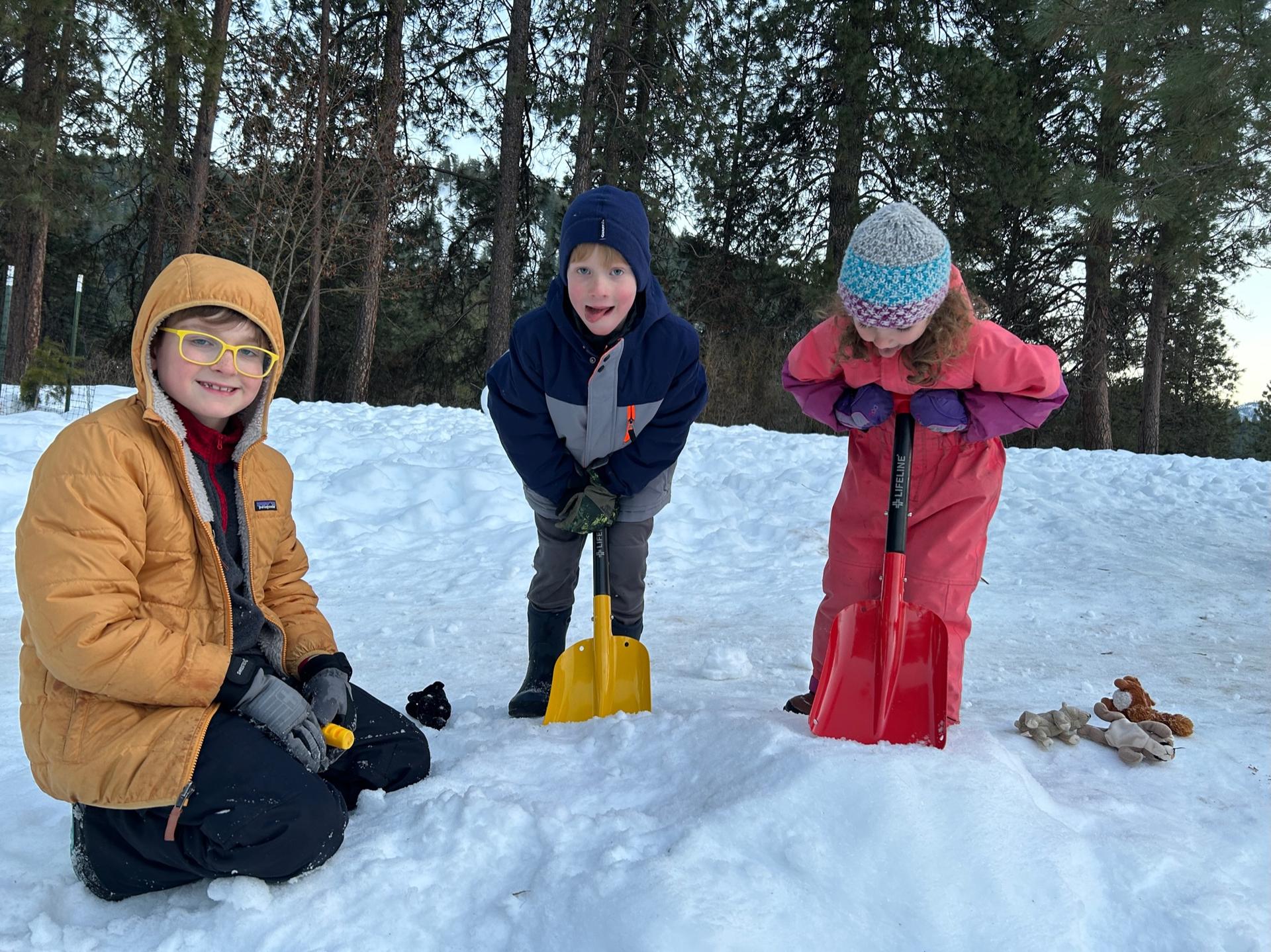 A picture of kids digging in snow with shovels during WRI After School Program