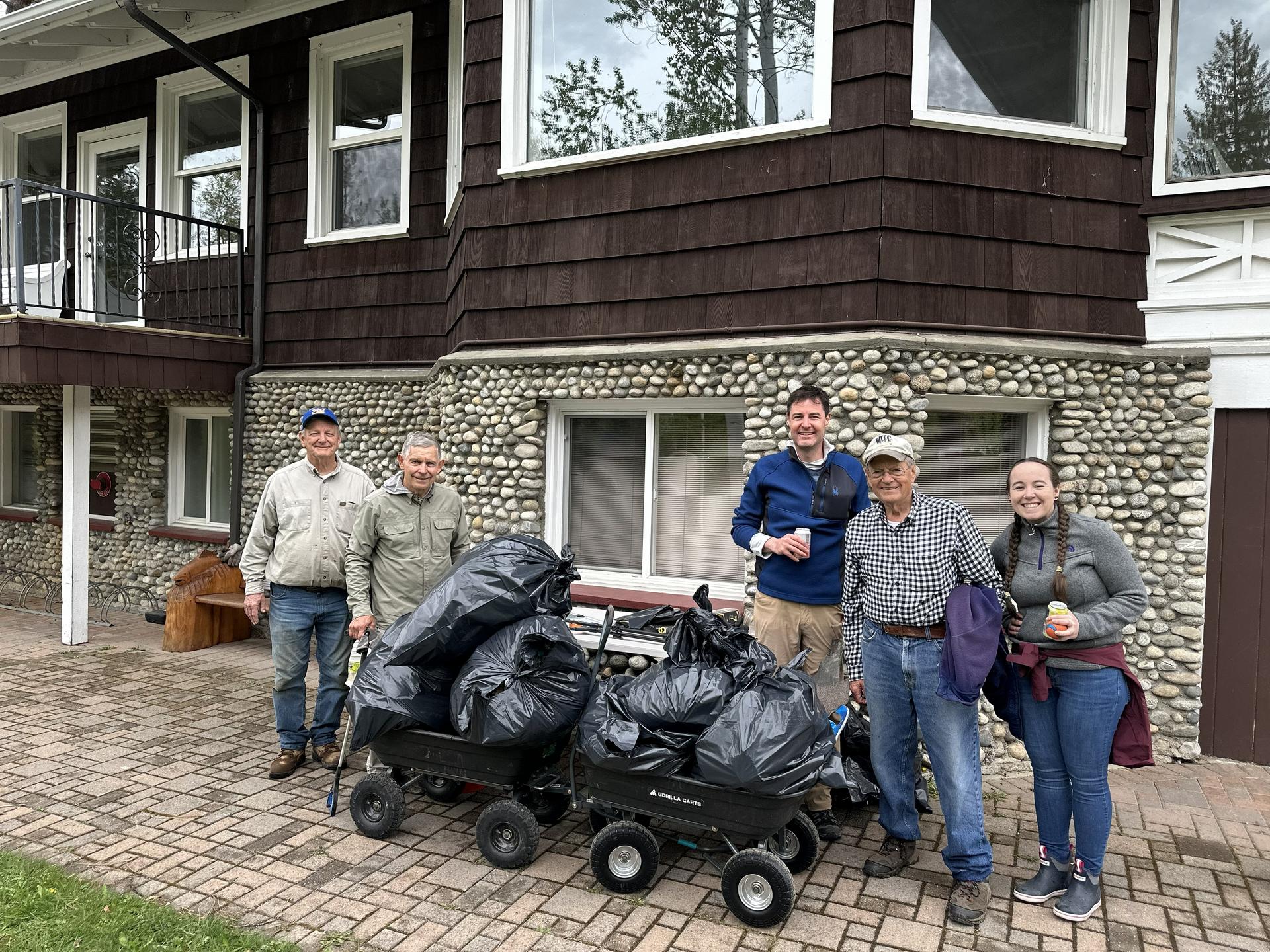 Volunteers standing near pounds of trash picked up during WRI's Earth Day Trash Pickup volunteer event.