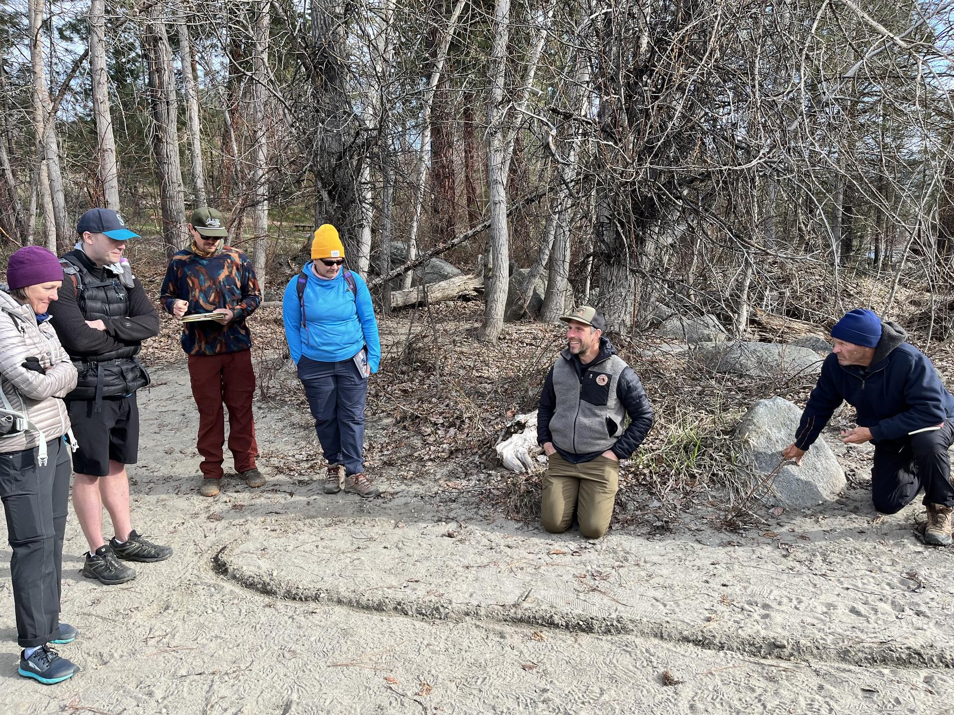 Image of a track and sign course lesson in a sandy river bank.