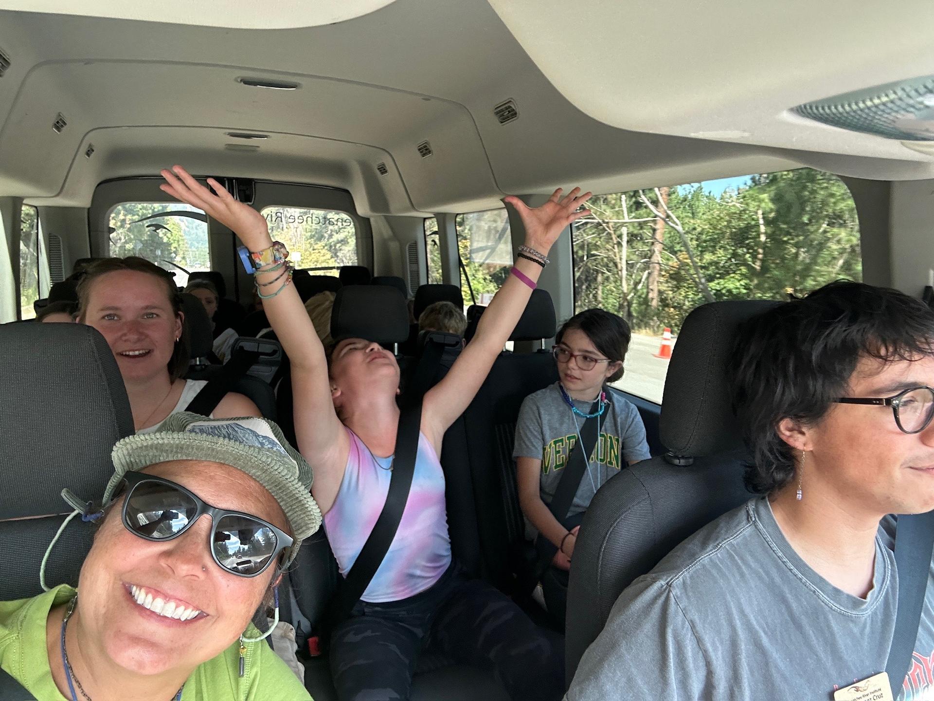 Picture of WRI Staff and Summer Camp students riding in a van.