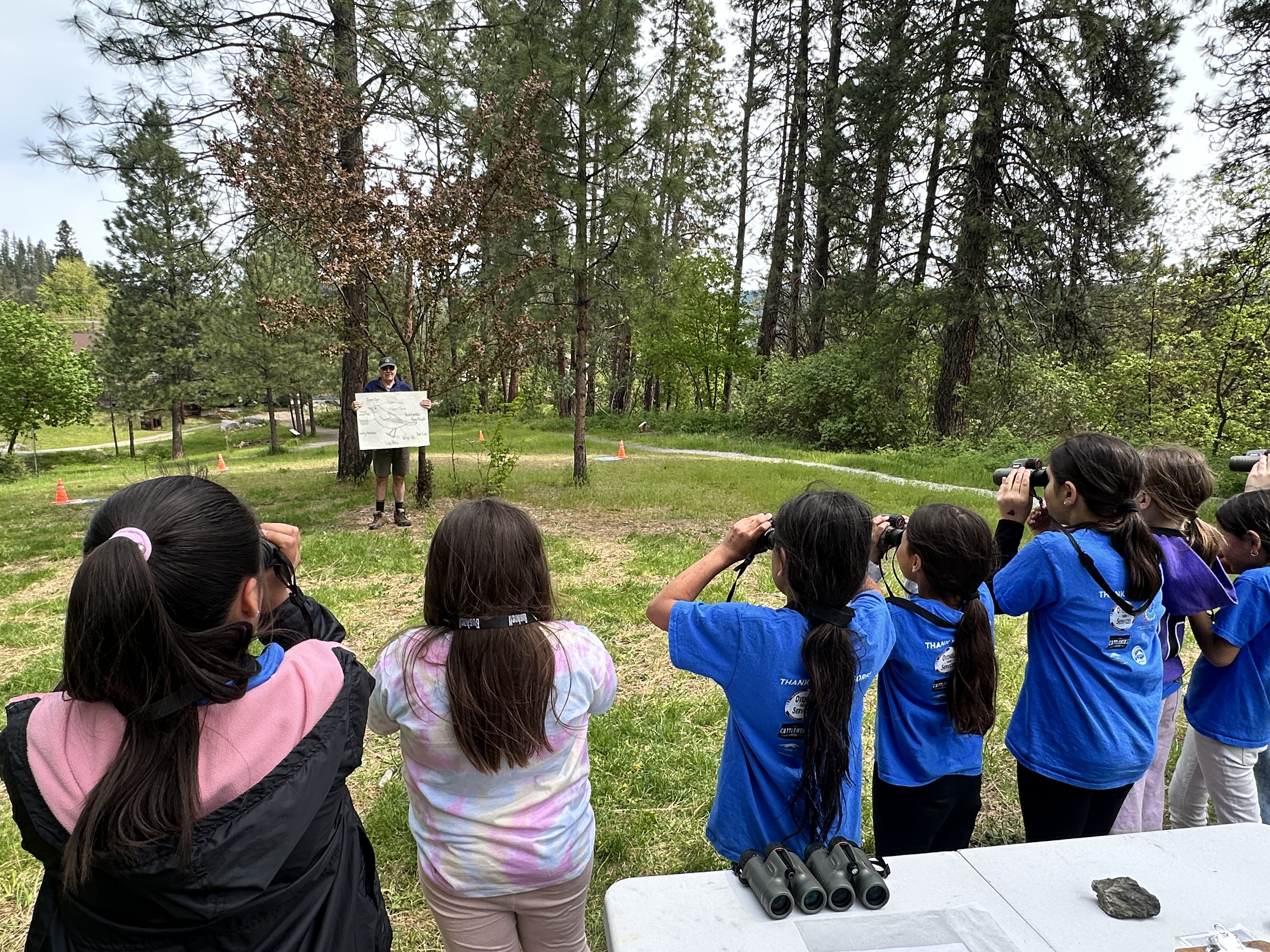  A line of girls during a WRI Wild Bird Field Day searching in a line with binoculars.