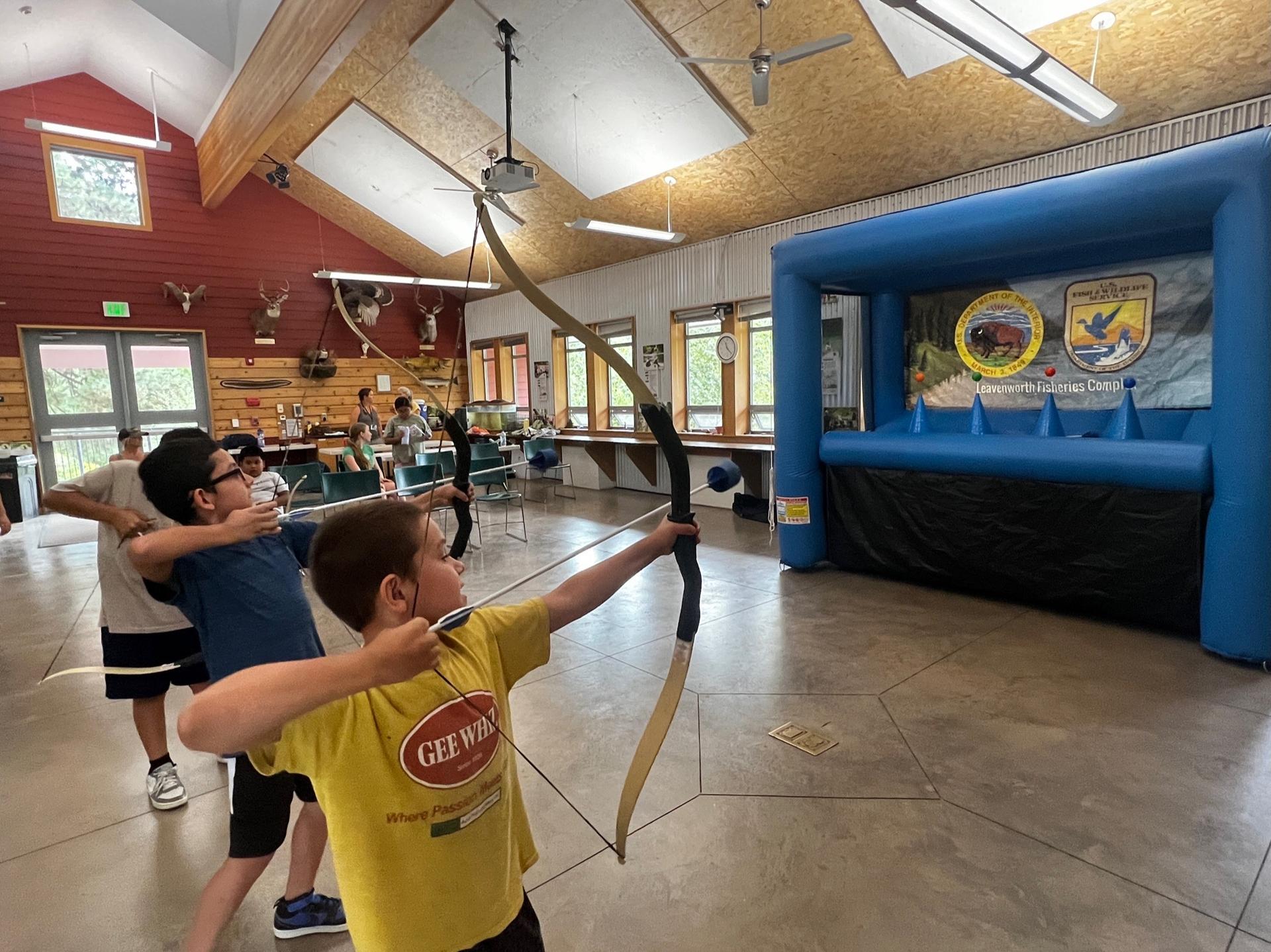 Campers in the Red Barn during the inflatable archery activity during camp