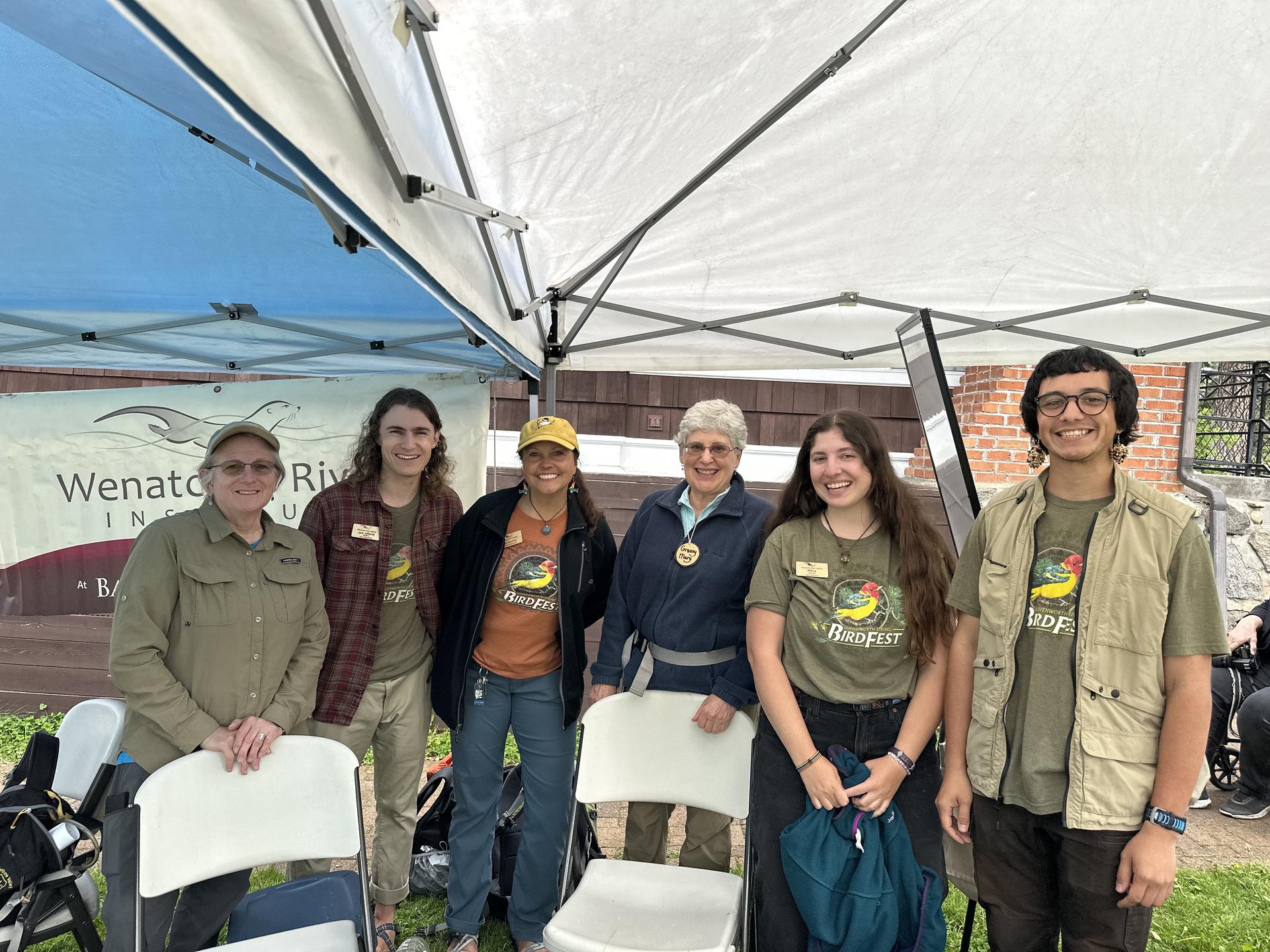 WRI Staff and volunteers wearing prior Bird Fest merchandise at 2025 Community Fair