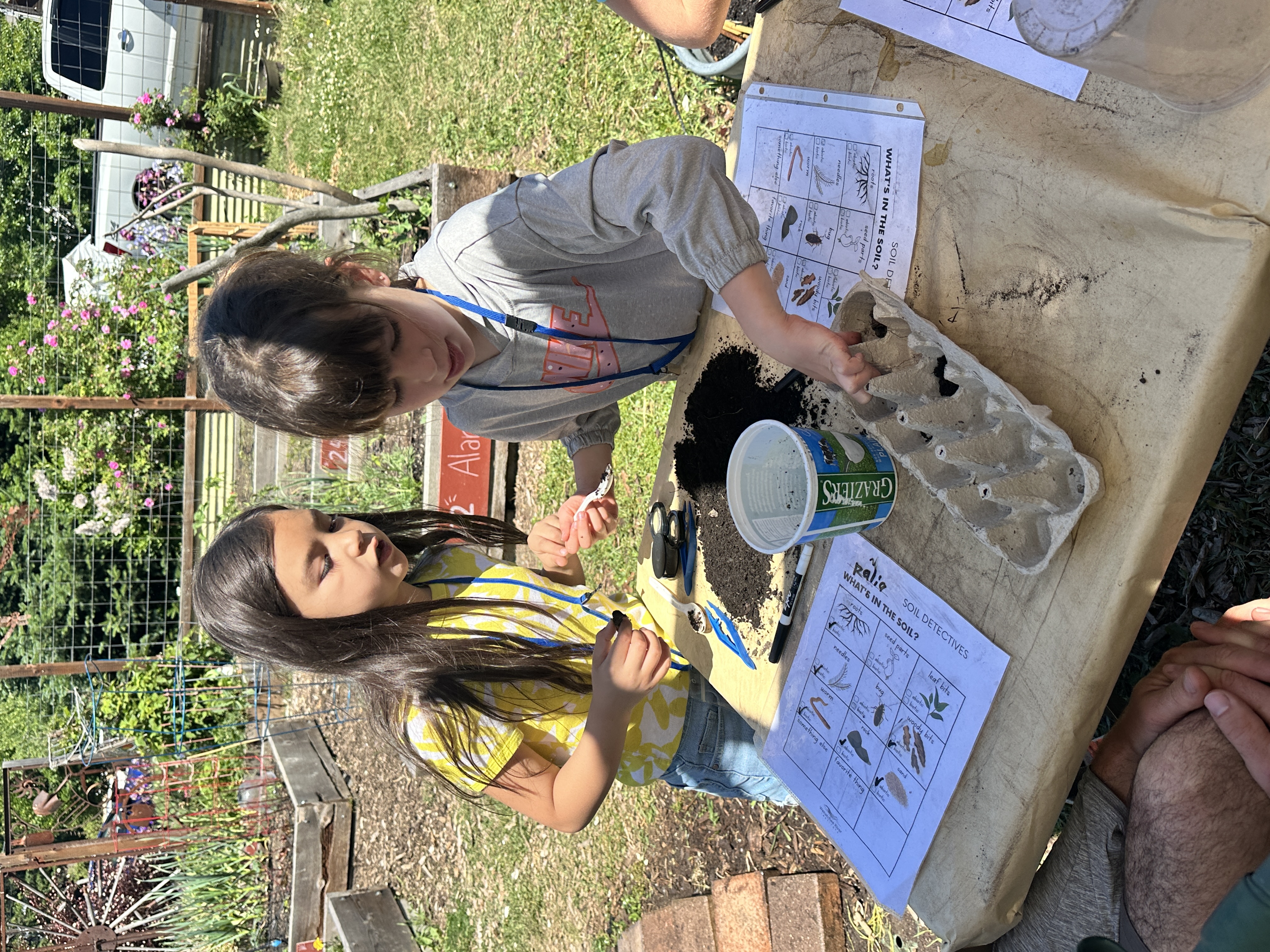 Two students playing Nature Detectives during a 1st grade field trip to Wenatchee River Institute.