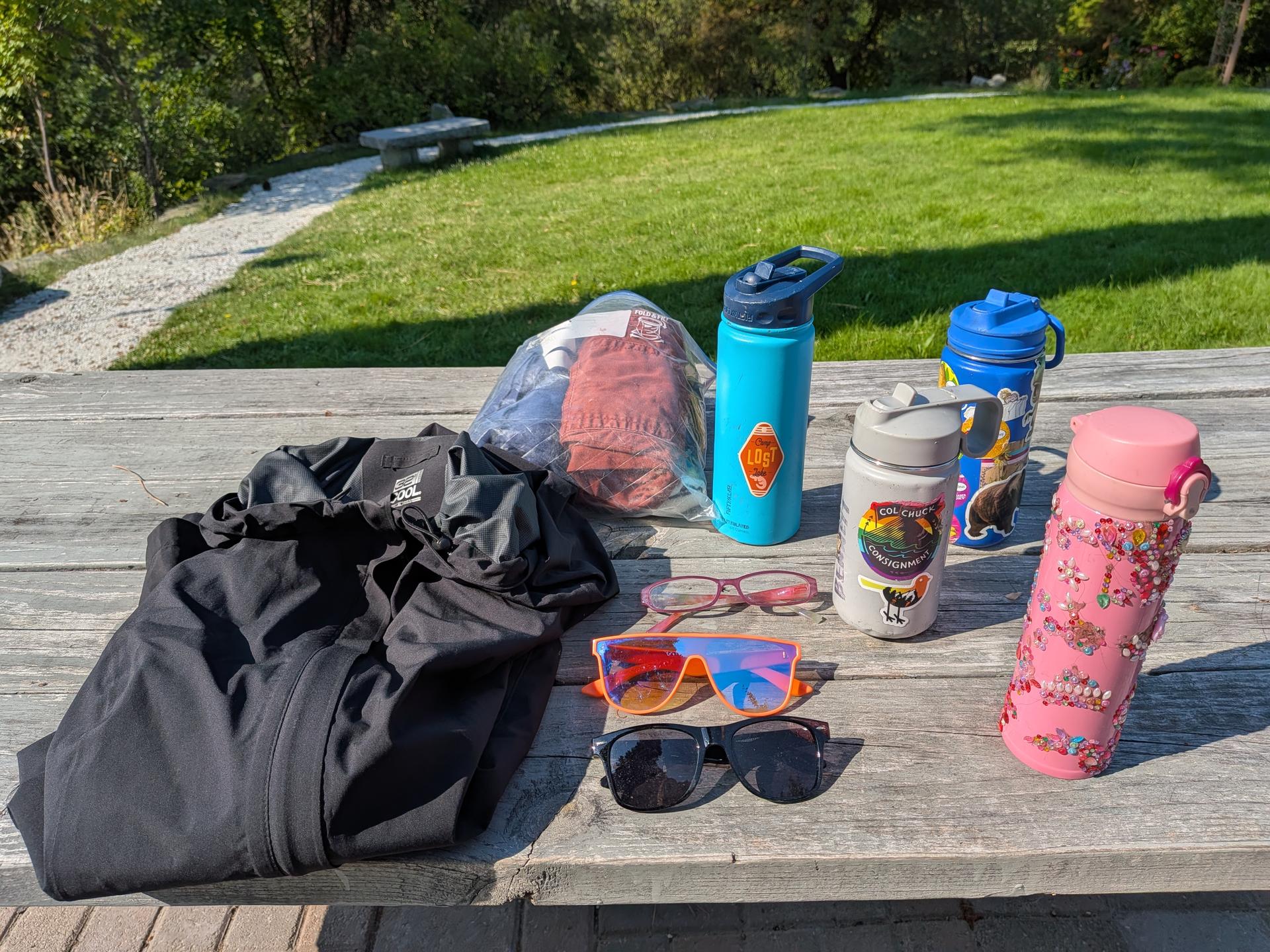 Image of water bottles, sun glasses, and misc clothing from WRI Lost & Found.