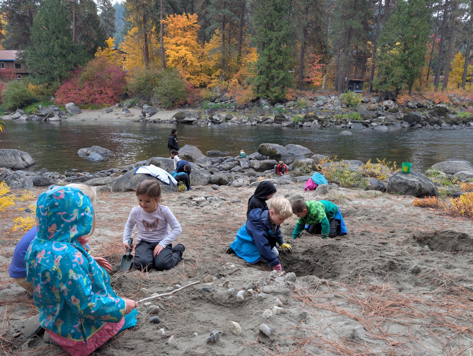 A picture of two boys testing water of the Wenatchee River.