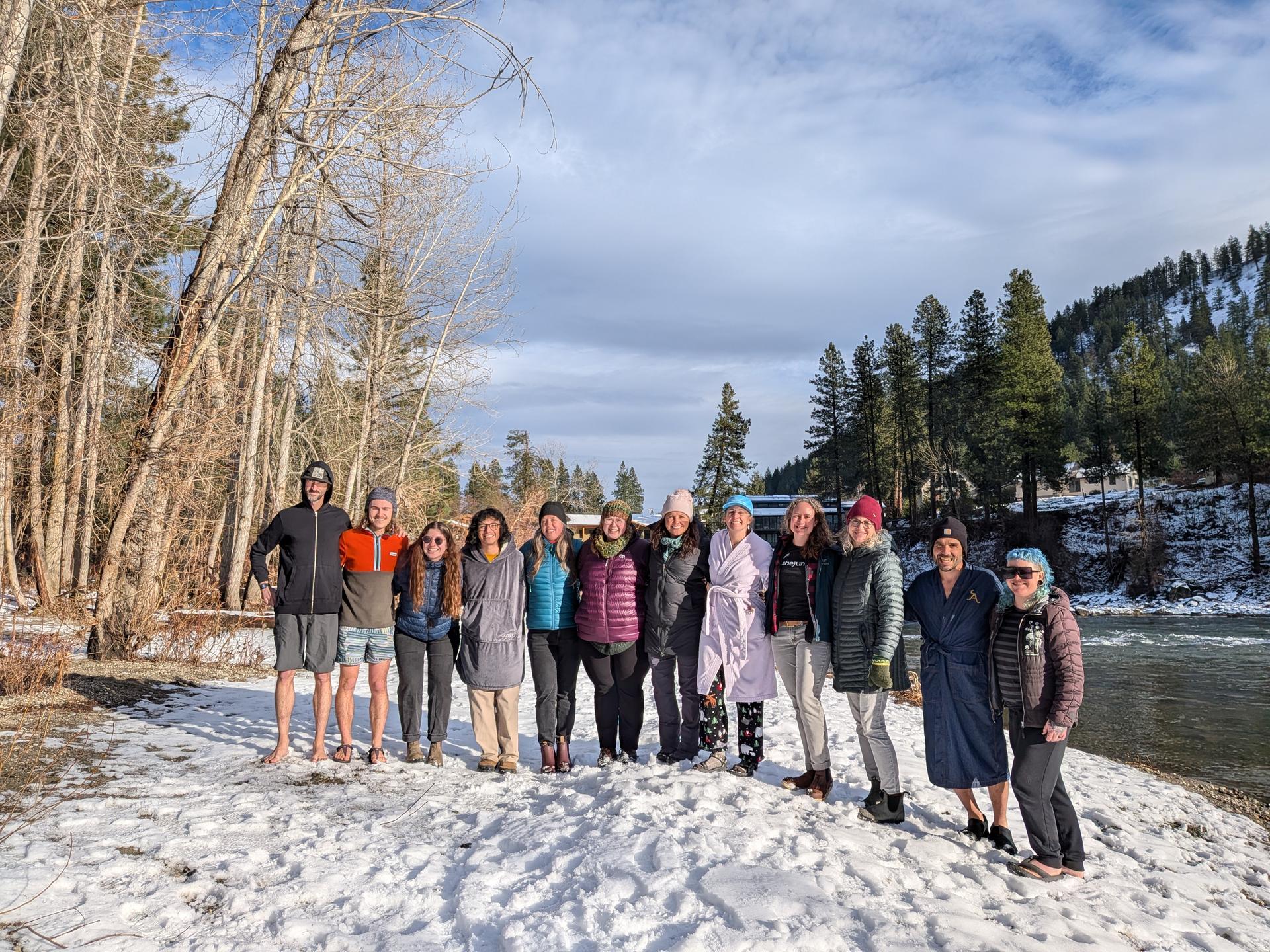 A group photo of WRI Staff by the Wenatchee River before the polar plunge