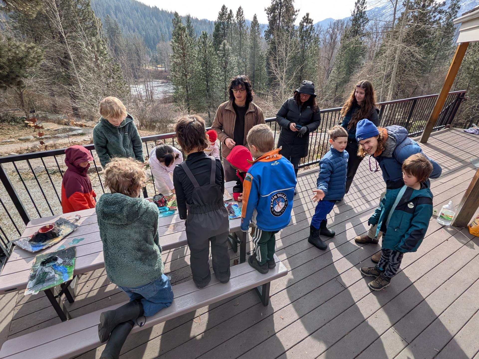 Kids on the WRI's Red Barn porch doing volcano eruption experiments. 