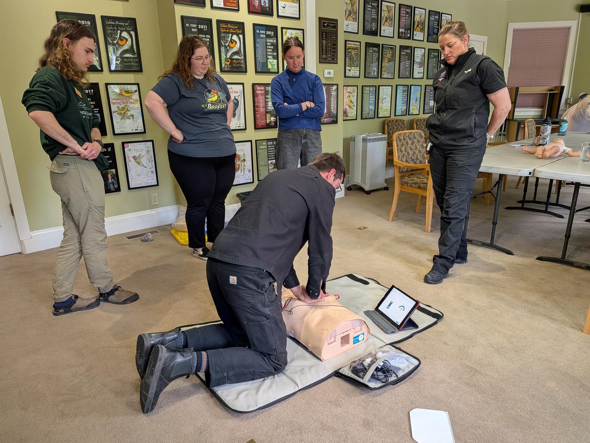 WRI Staff doing CPR training in the Bird Fest Room with Cascade Ambulance.