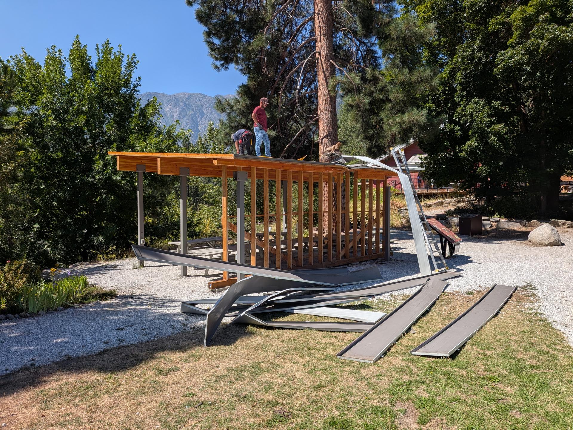 Image of construction workers standing on top of the Outdoor Classroom during repairs.