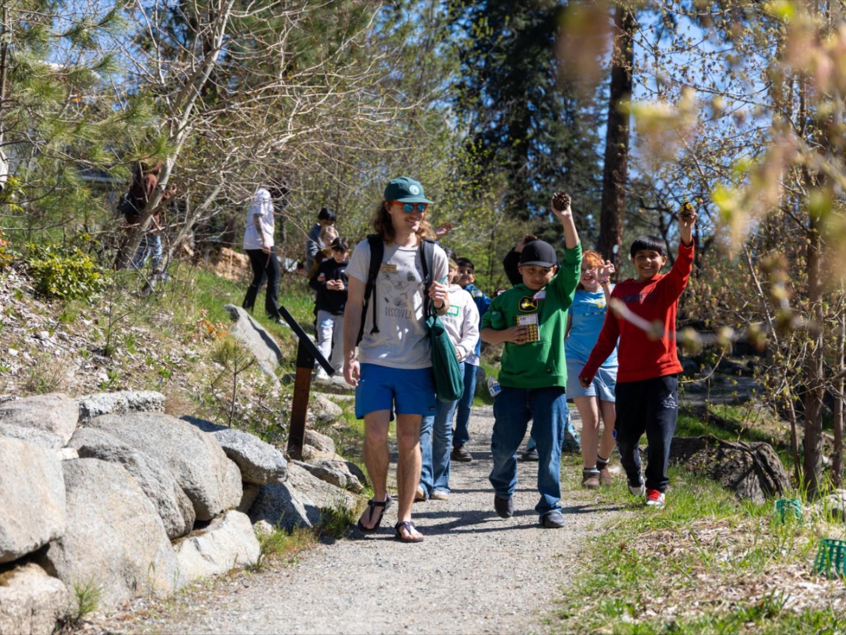 Traveling Naturalist Field Day at WRI. Students walking down the trails on the campus with WRI Educator, Jack.
